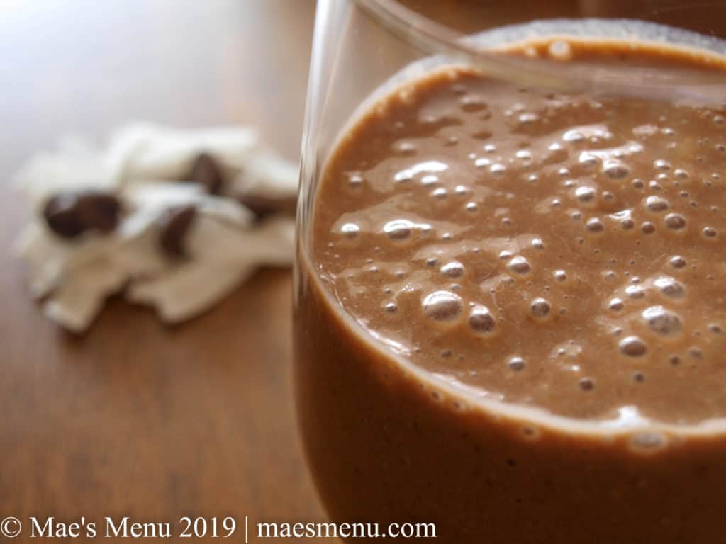 Up-close of healthy chocolate smoothie with banana and coconut.