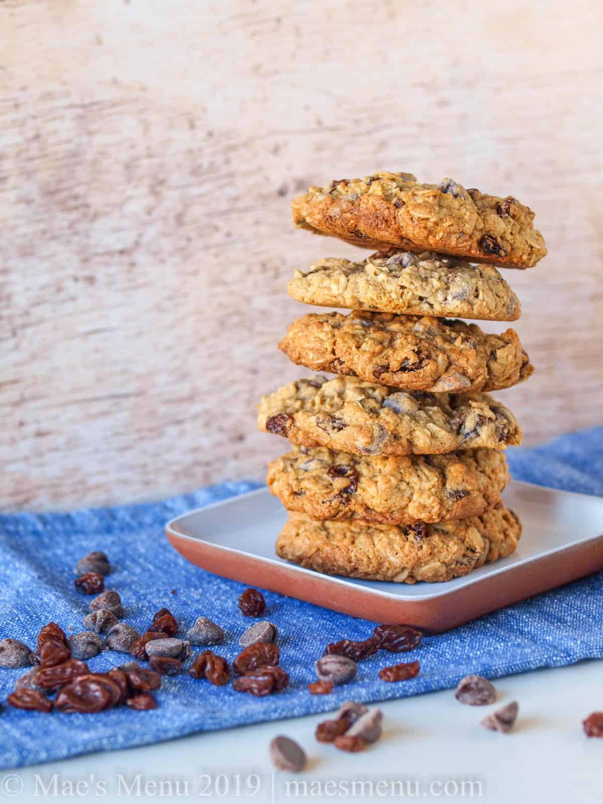 A tall plate of oatmeal raisin chocolate chip cookies