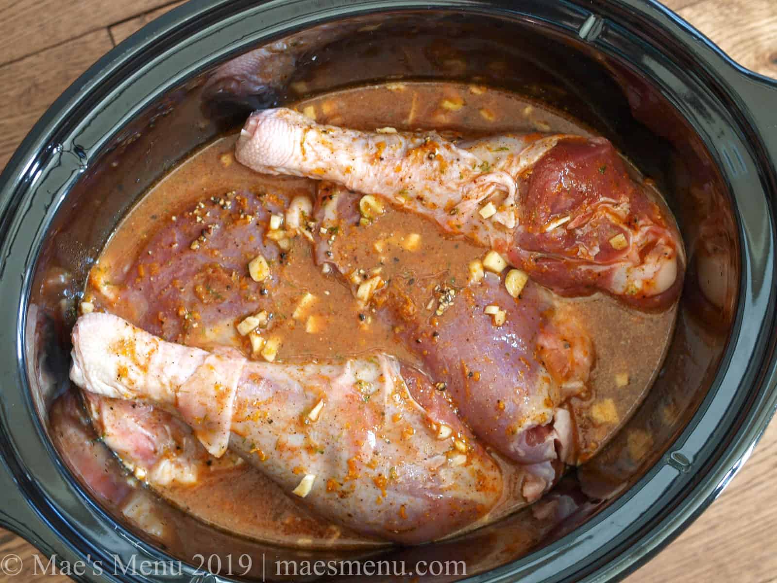 Turkey legs in carnitas seasoning in a slow cooker