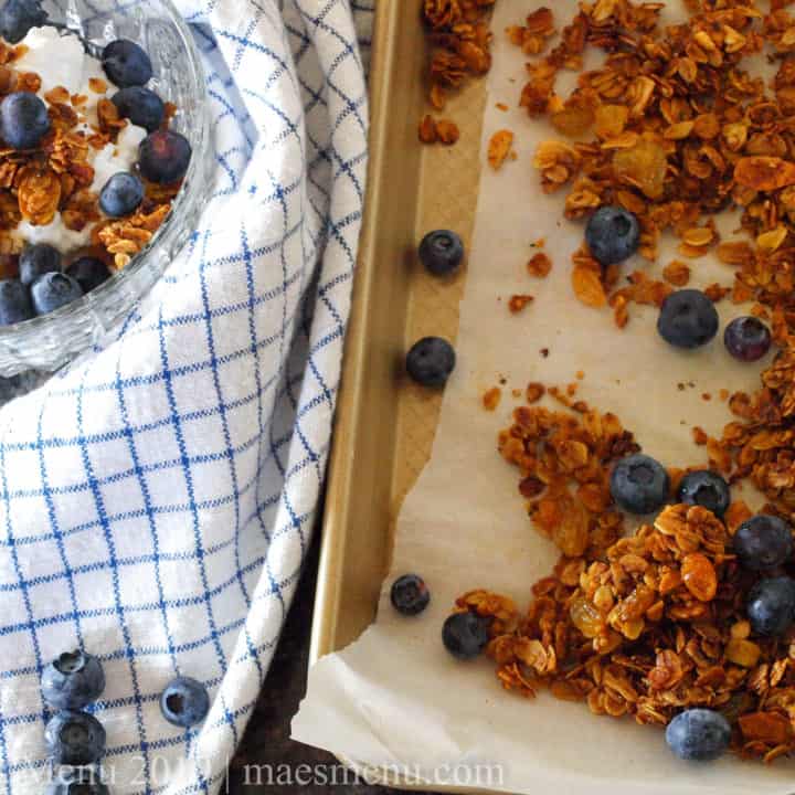 Crunchy turmeric granola with blueberries and on a dish of cottage cheese.