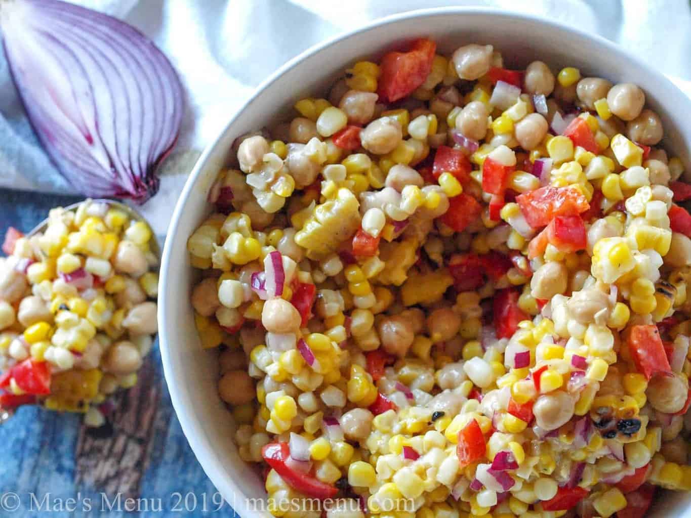 Large white bowl of Chickpea & Grilled Corn Salad with Roasted Garlic Vinaigrette
