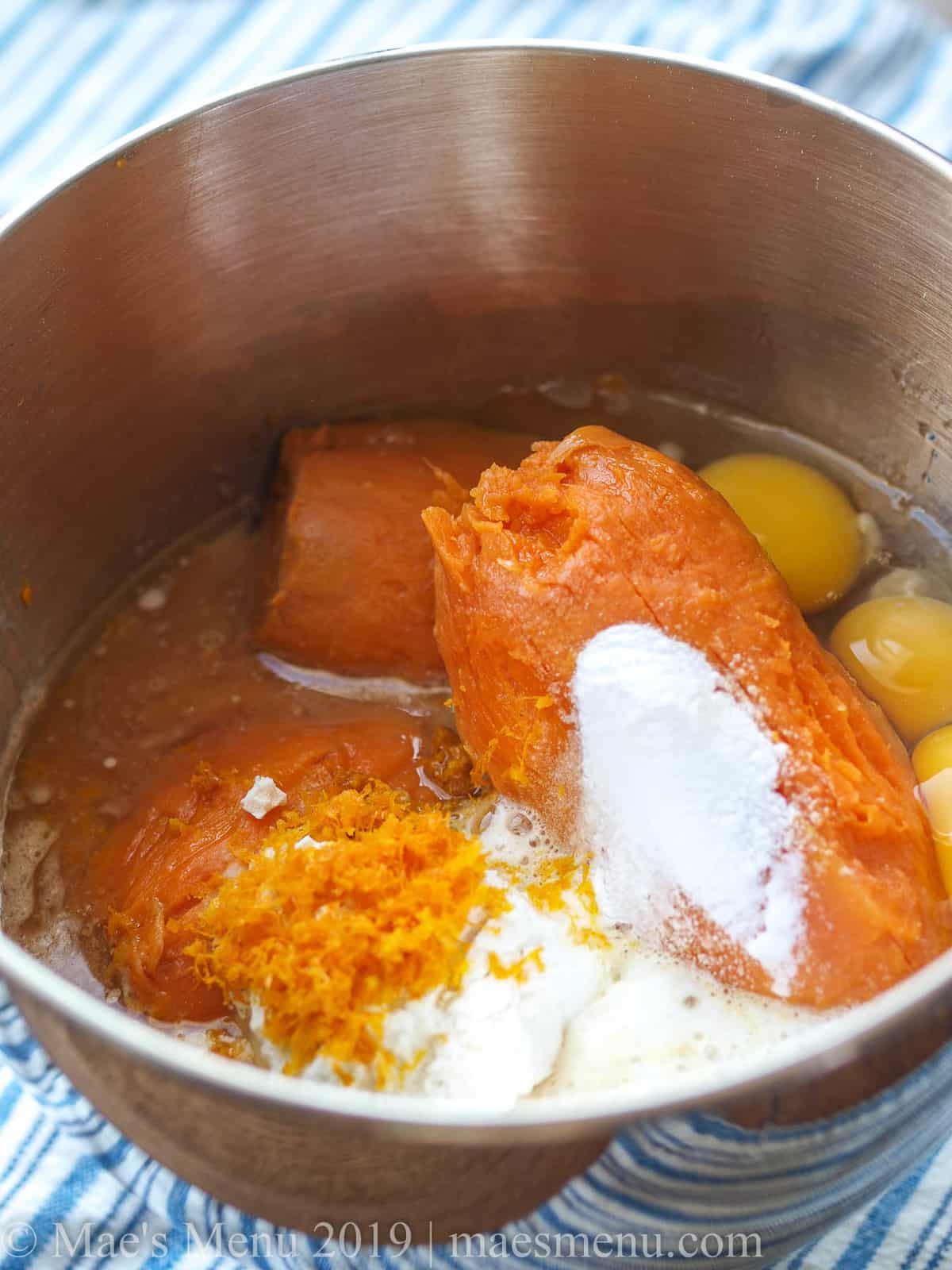 All the ingredients for a healthy sweet potato soufflé in a metal mixing bowl