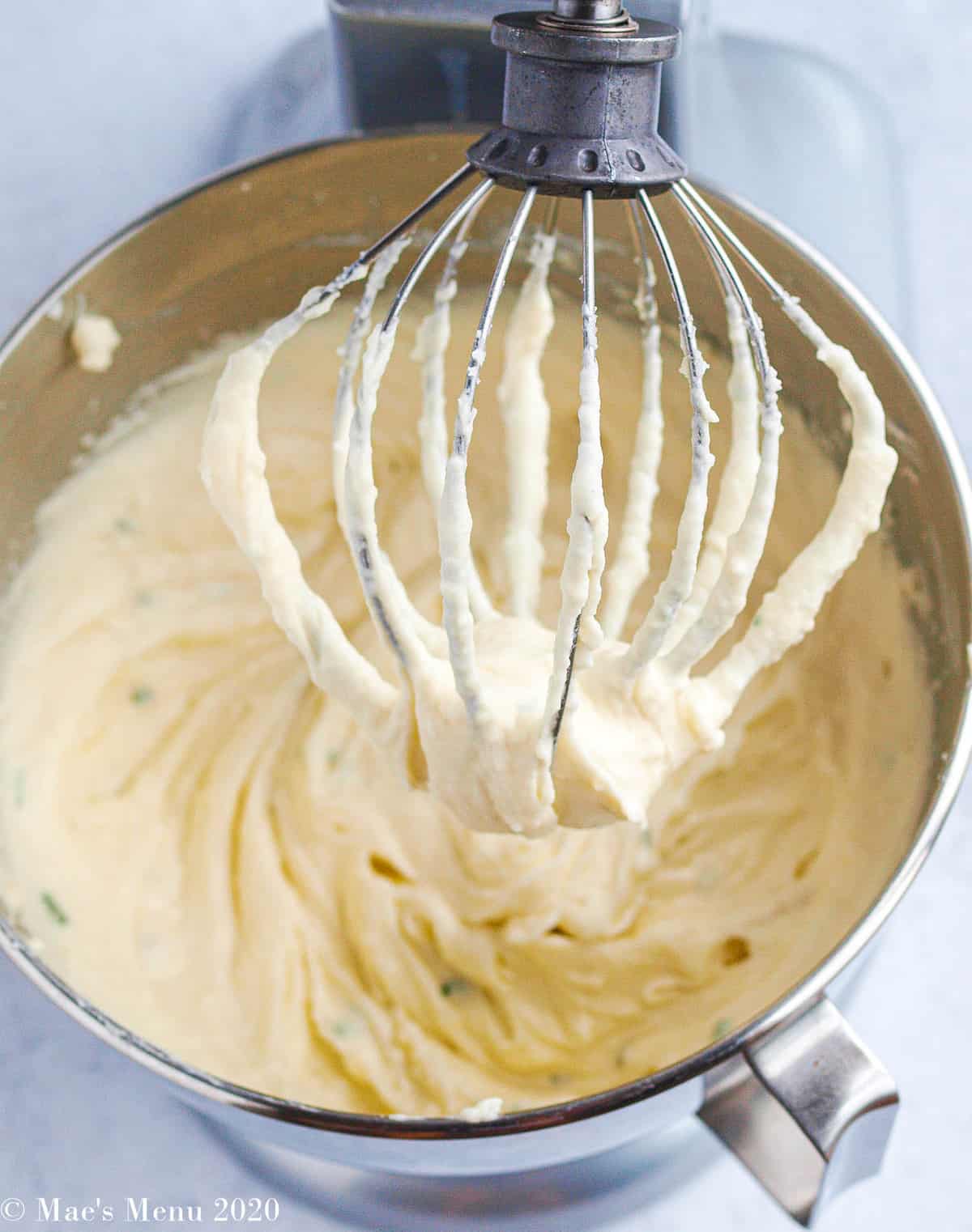 Creamy whipped potatoes in a stand mixer with a whisk attachment