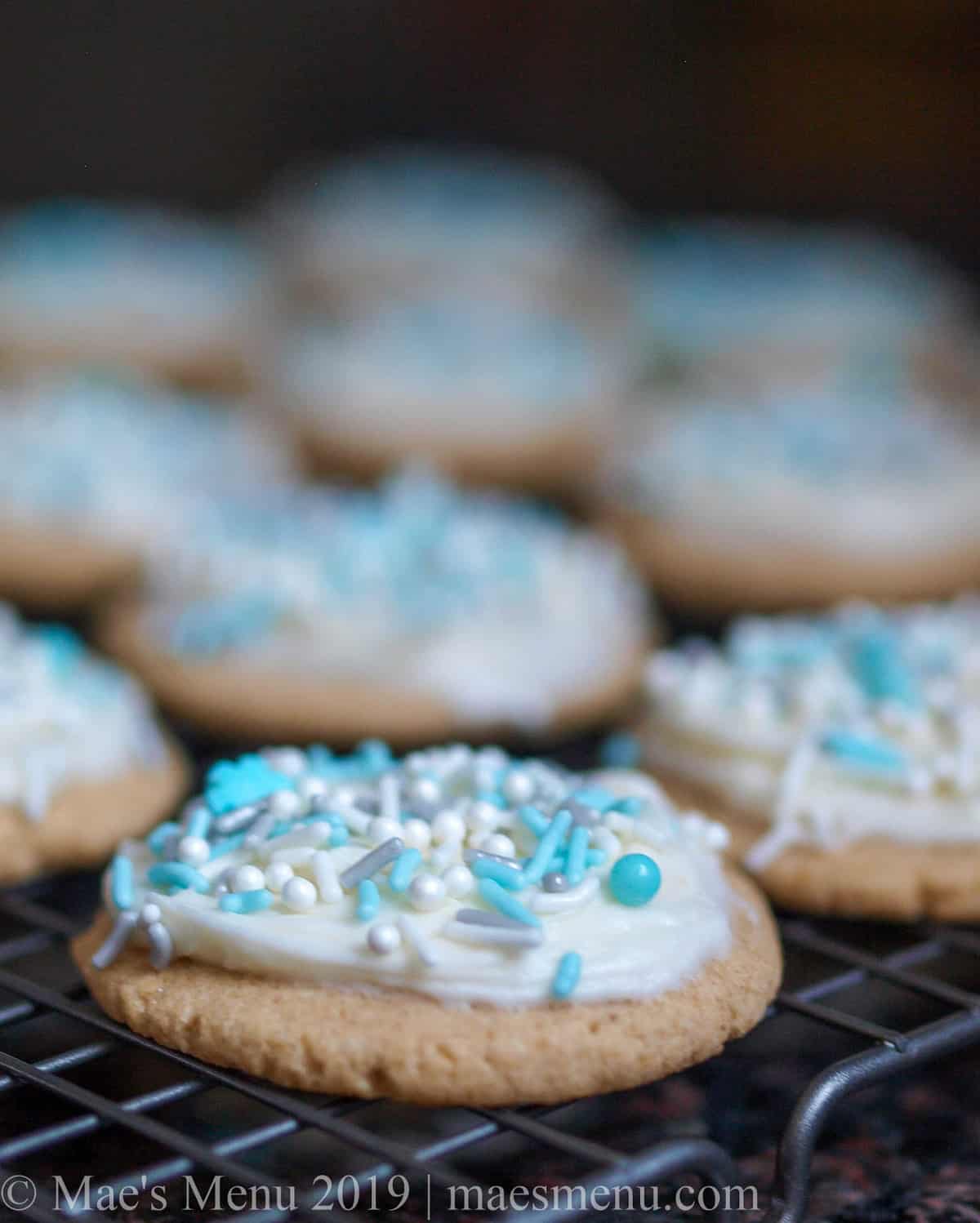 A side shot of a high altitude sugar cookies on a cooling rack.