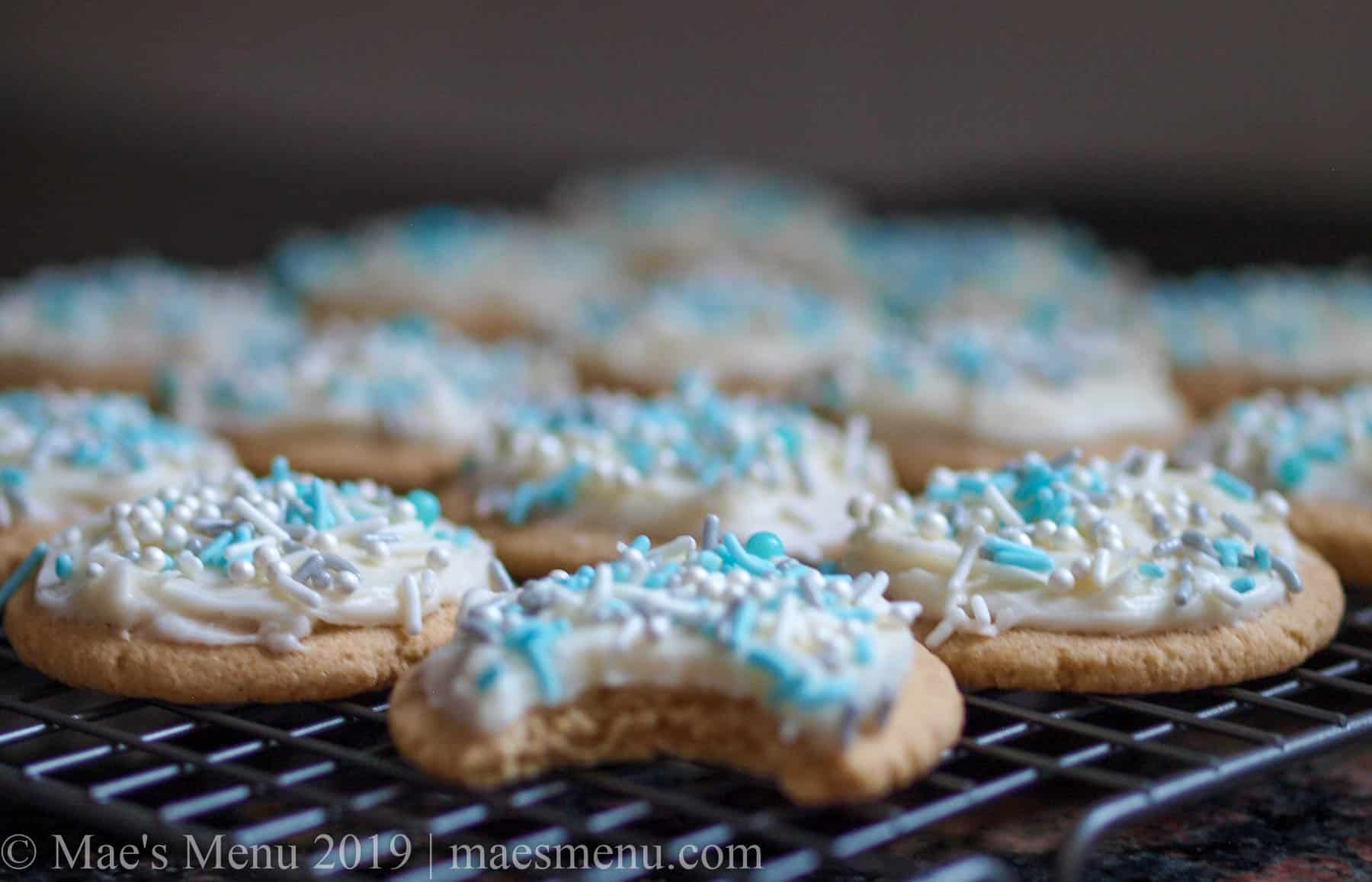 A tray of cooking sugar cookies with vanilla cream cheese frosting. 
