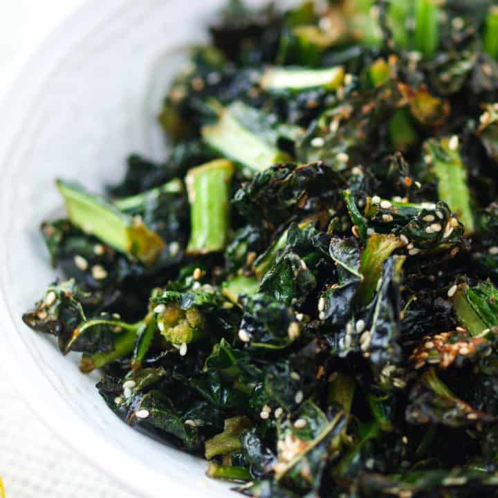 A large bowl of air fryer kale chips with sesame.