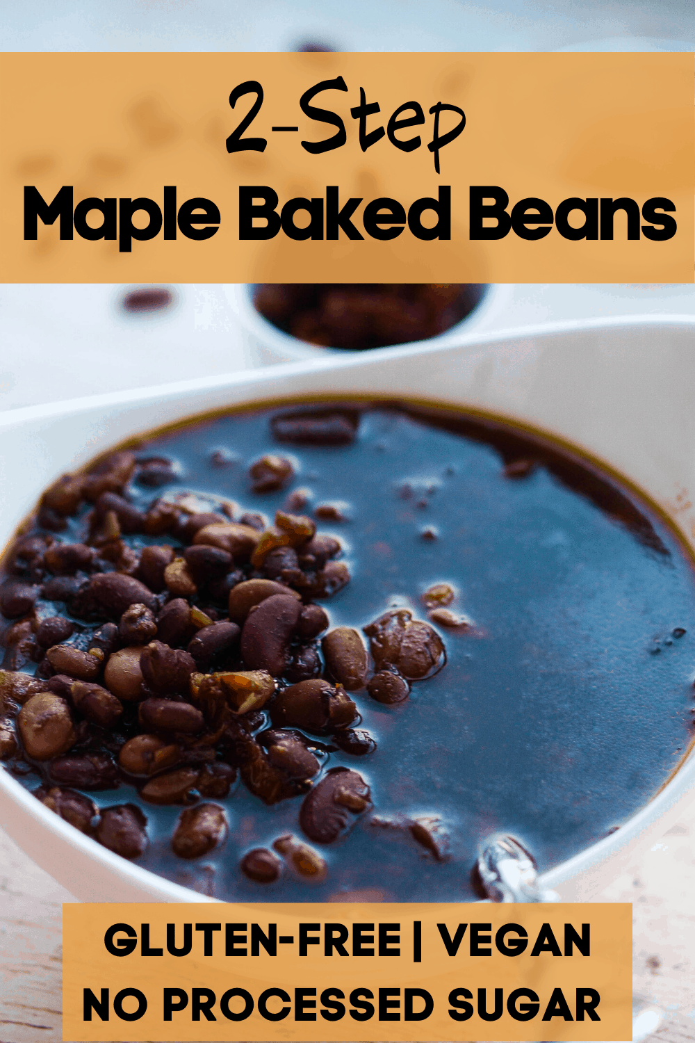 A pinterest pin for maple baked beans. On the picture is a large bowl of maple baked beans.