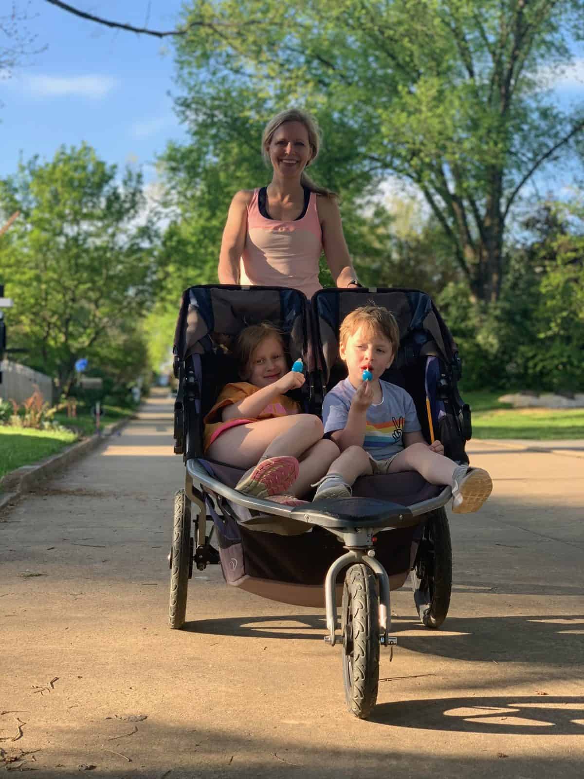 Whitney Heins, of Mother Runners, with her kids in the running stroller.