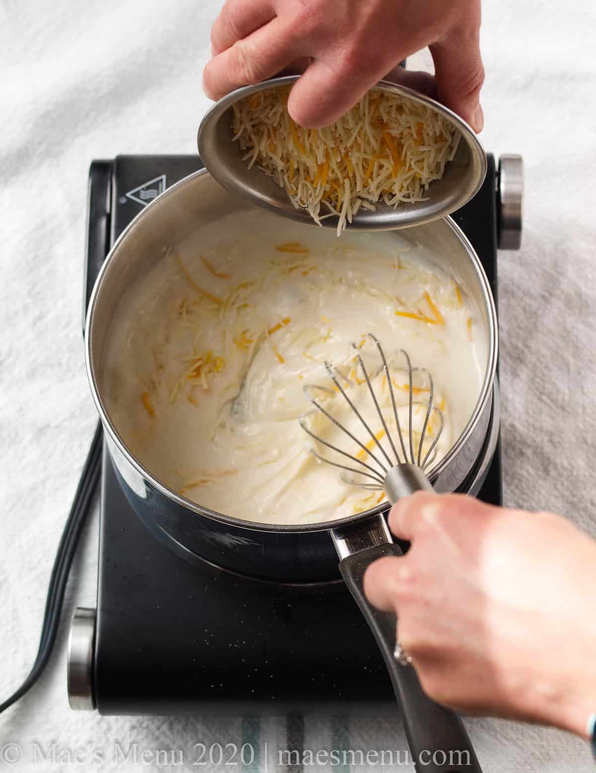 Whisking the cheese into the roux