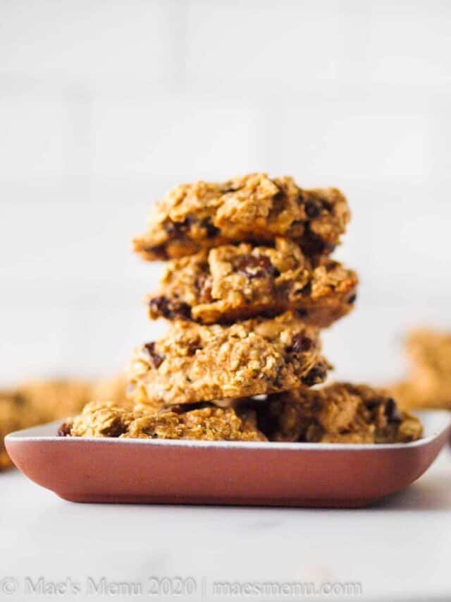 A stack of oat protein cookies on a small clay plate.