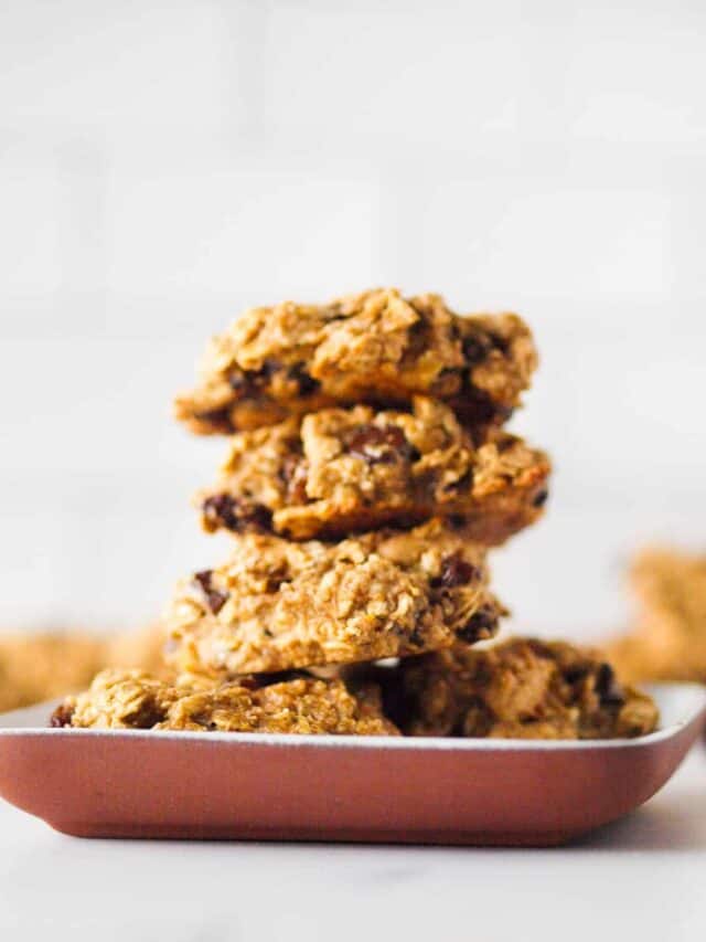A stack of oat protein cookies on a small clay plate.