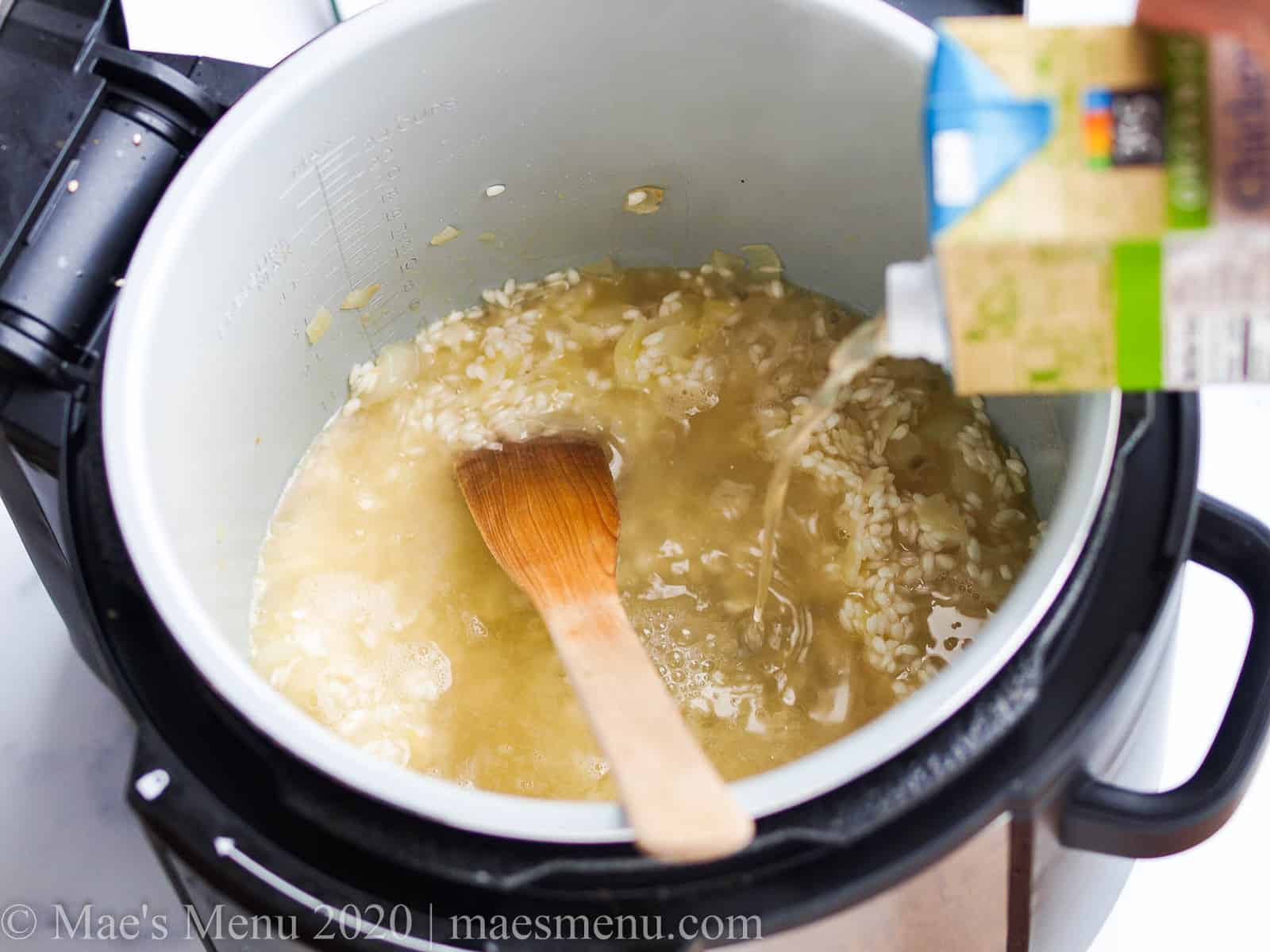 Pouring chicken broth into the instant pot with rice 