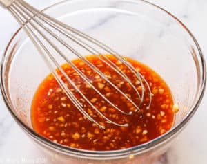 Whisking the marinade in a mixing bowl