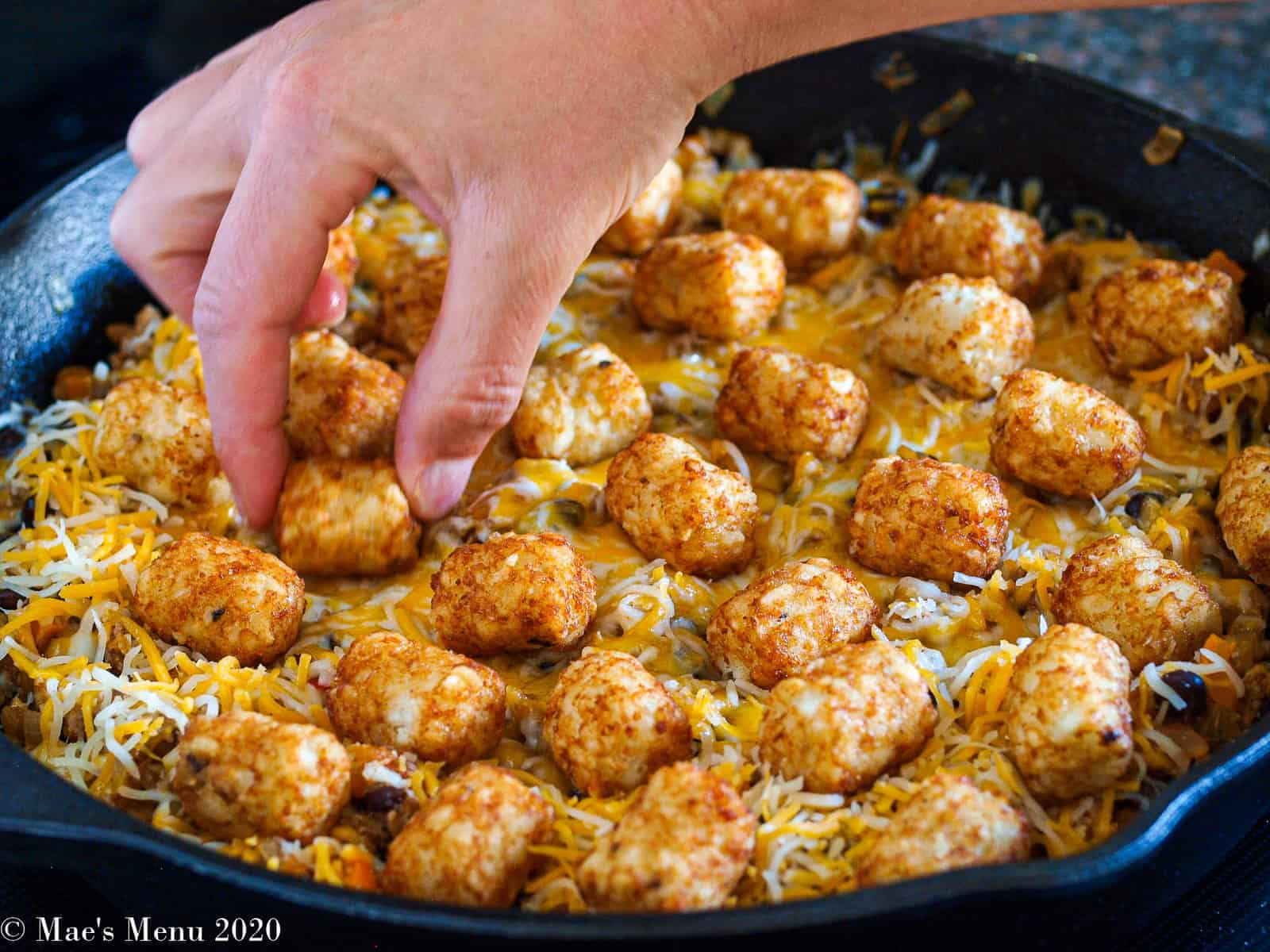 Placing hash browns on top of the taco tater tot casserole