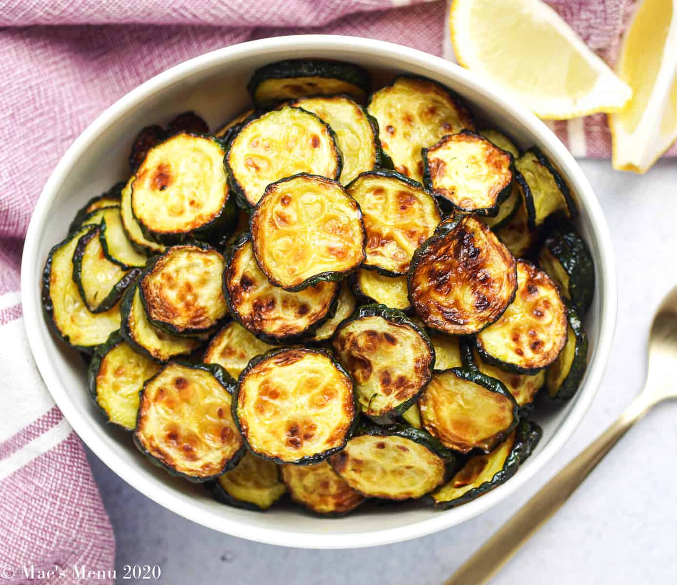 A small bowl of air fryer zucchini in a small white bowl
