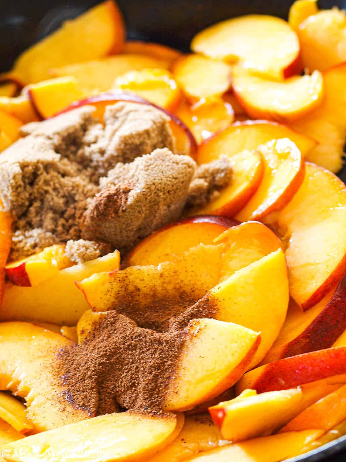 brown sugar and spices on top of peaches