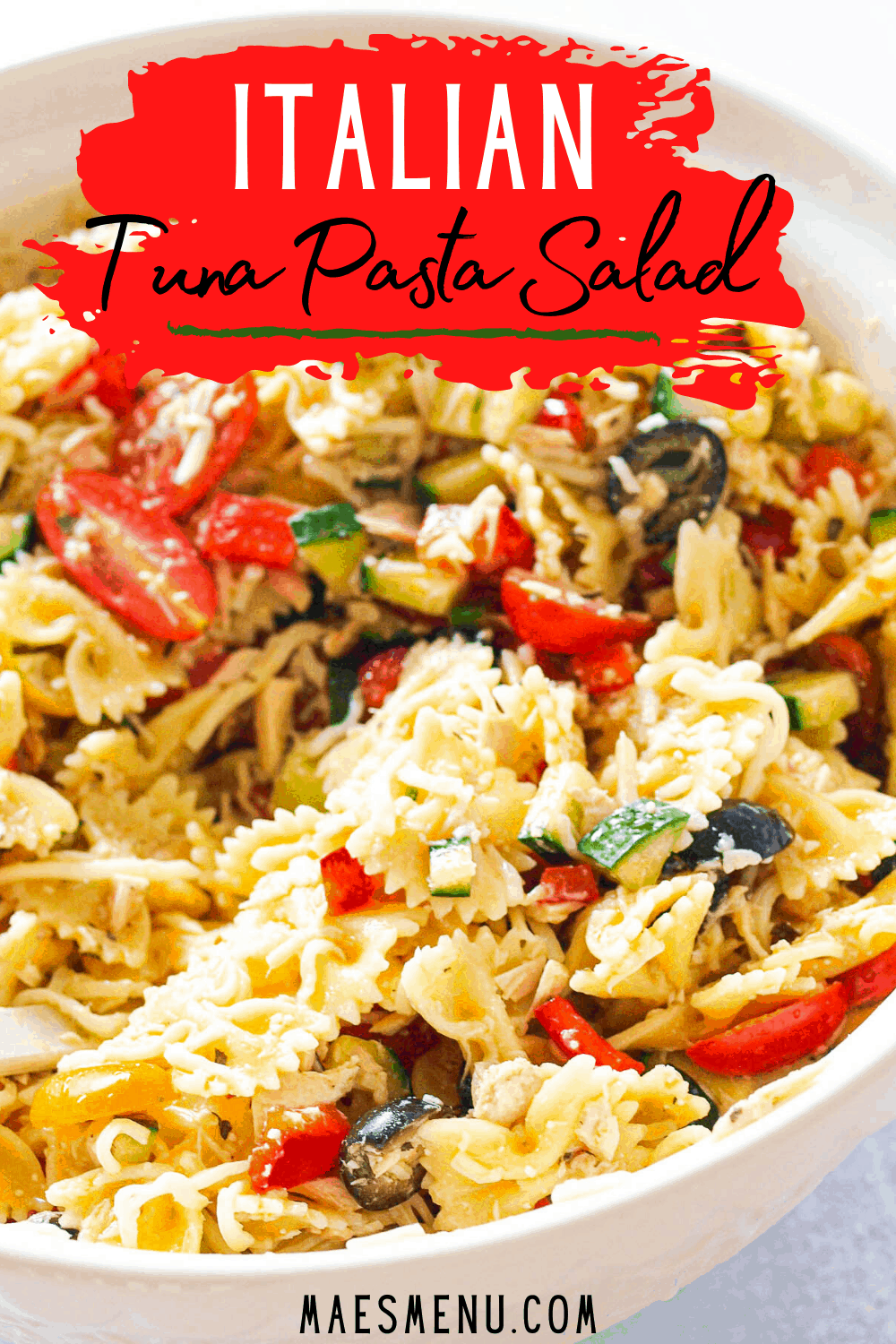 A pinterst pin for Italian tuna pasta salad. On the picture is a side shot of a white bowl of the pasta salad. 