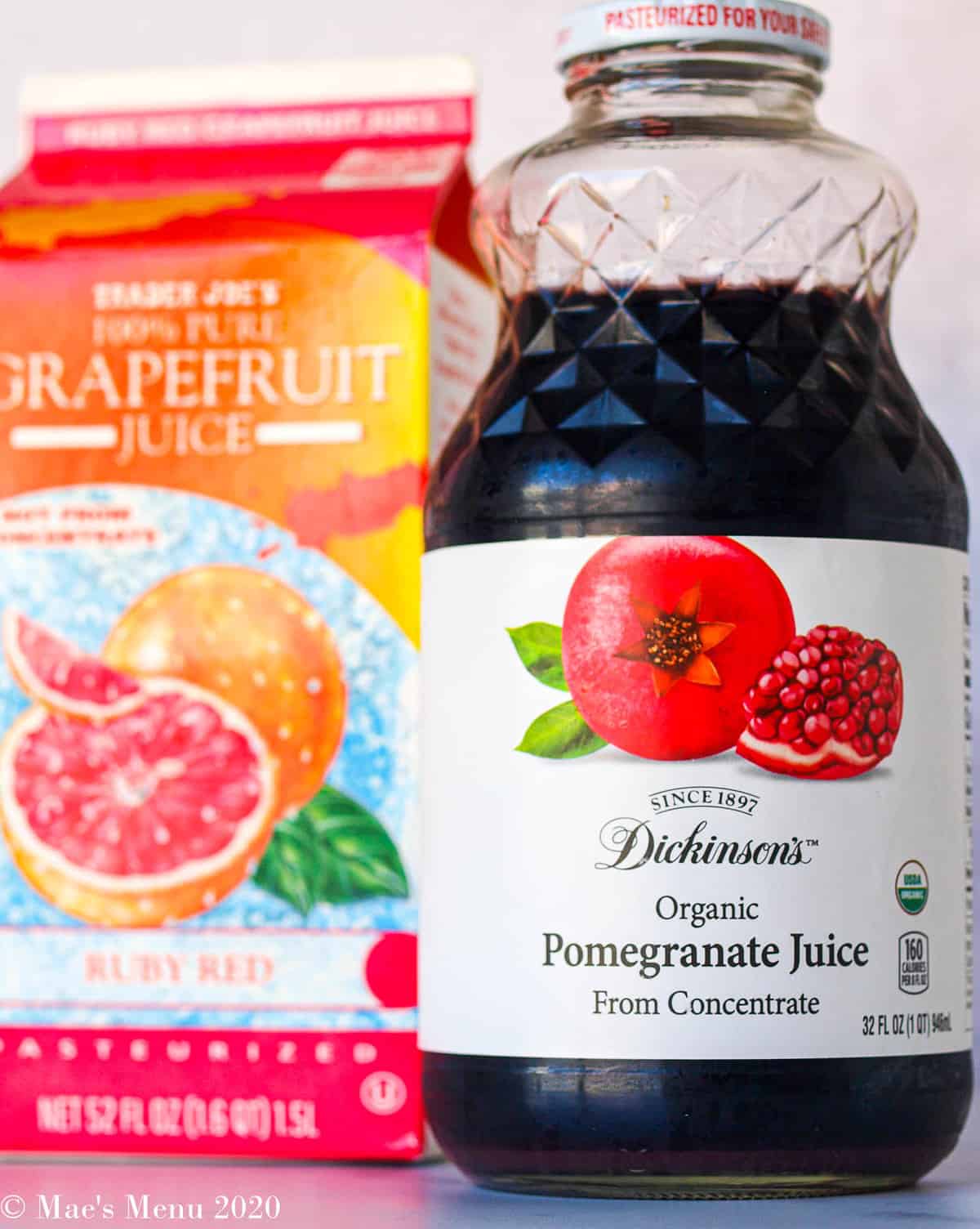 an up-close shot of a bottle of pomegranate juice and a carton of grapefruit juice