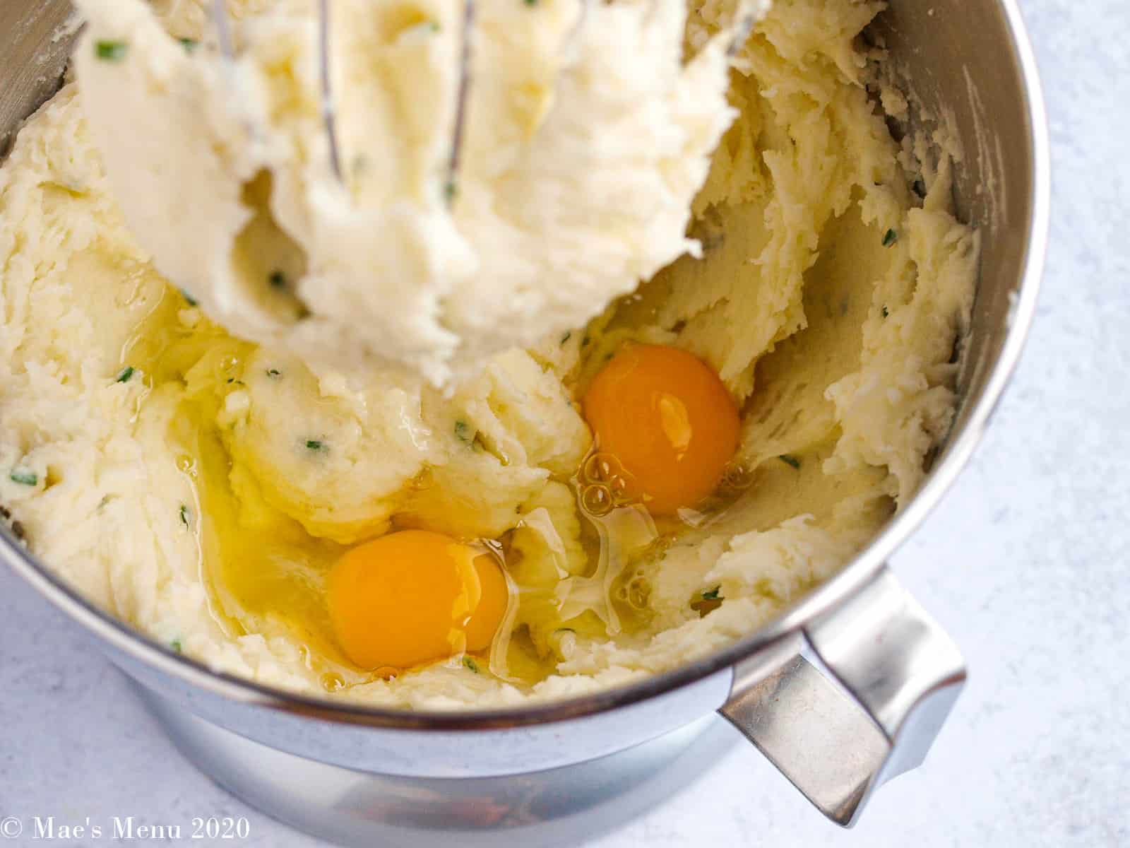 Eggs and mashed potatoes in a stand mixer with a whisk attachment