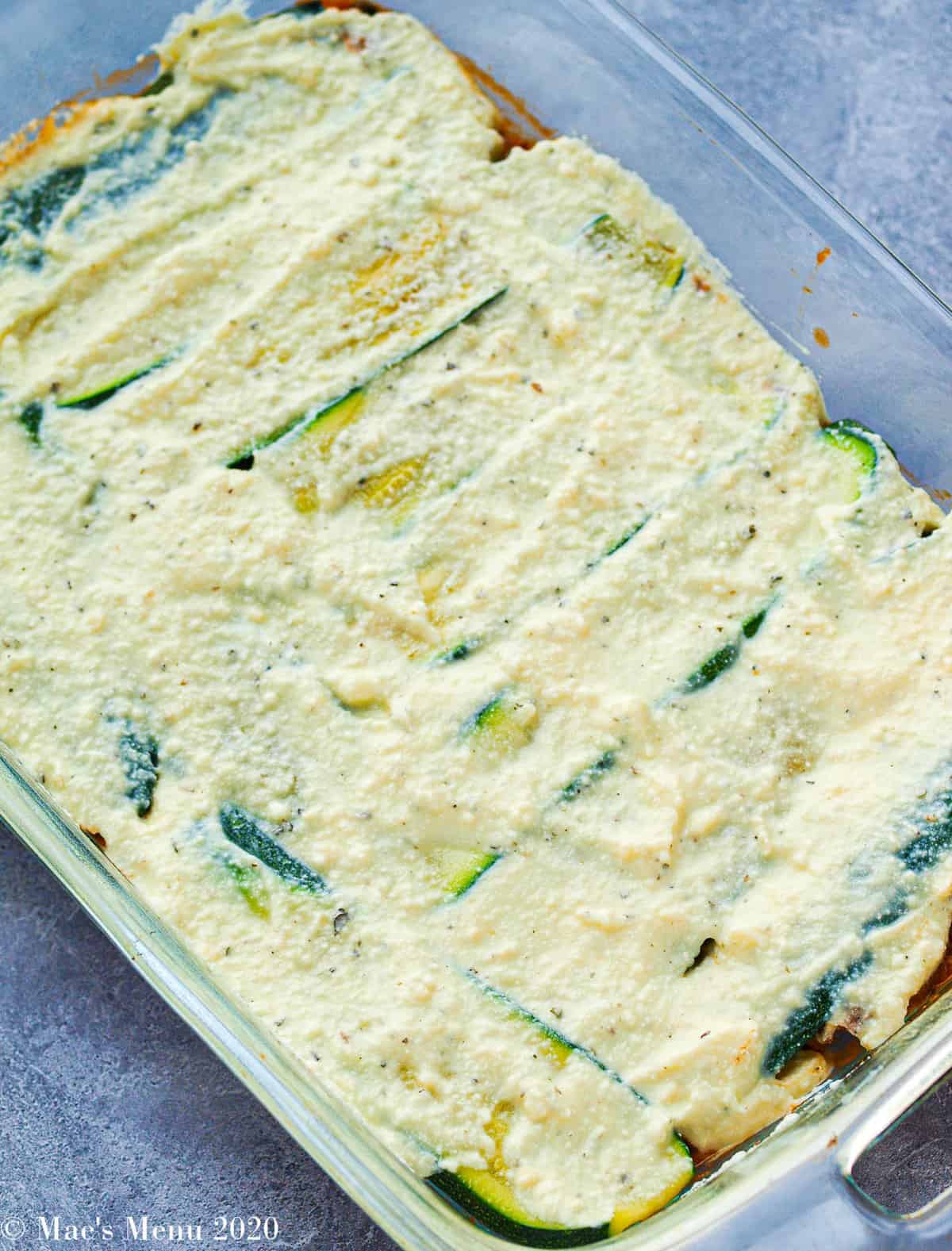 The third layer of zucchini lasagna: ricotta cheese mixture on top of the zucchini