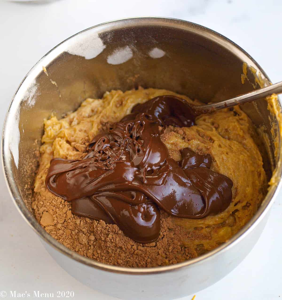 A small bowl of half the peanut butter banana bread batter with melted chocolate chips and cocoa powder