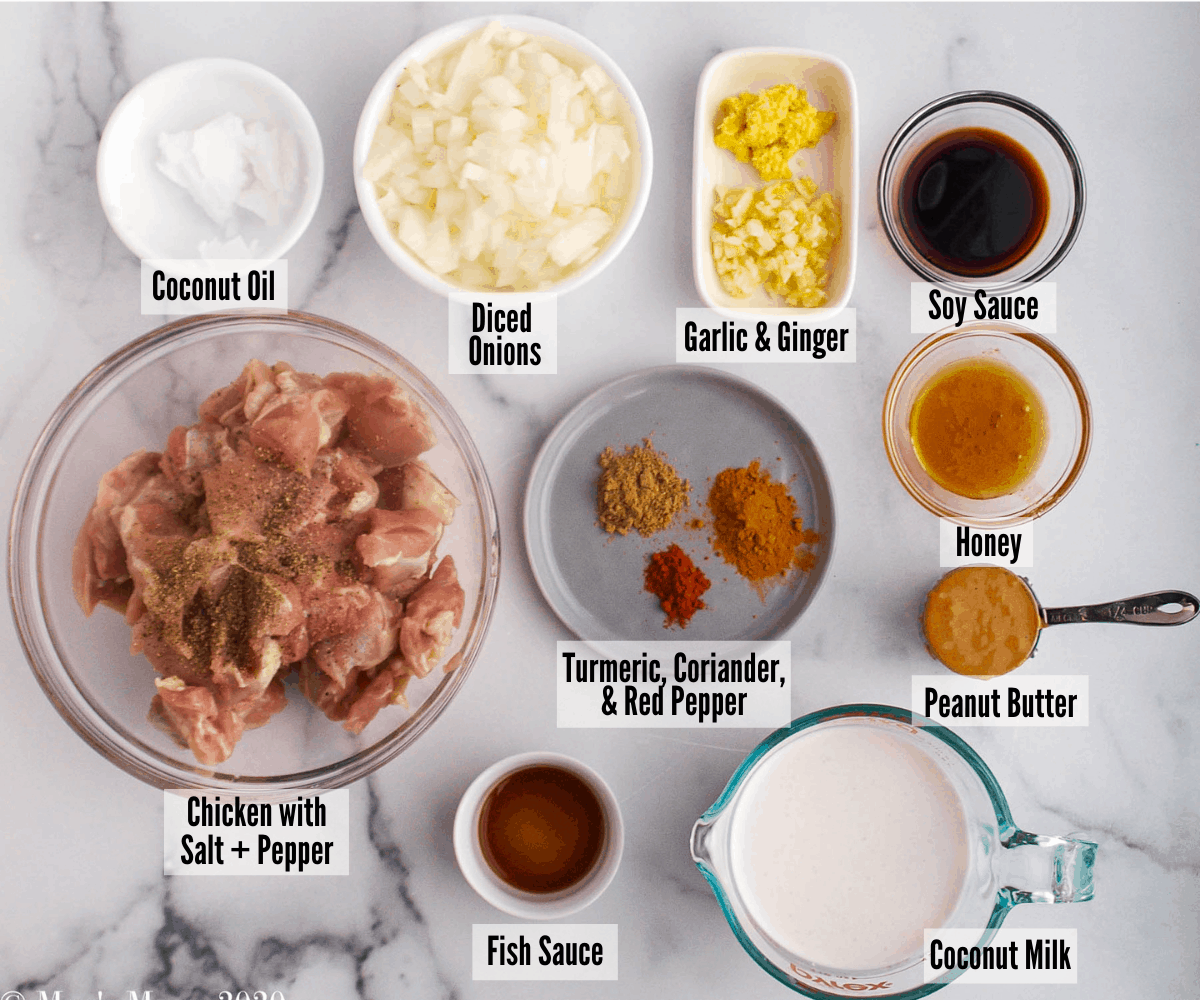 All the ingredients for peanut butter chicken curry: coconut oil, diced onions, garlic & ginger, soy sauce, honey, peanut butter, chicken, salt and pepper, turmeric, coriander, red pepper, fish sauce, and coconut milk