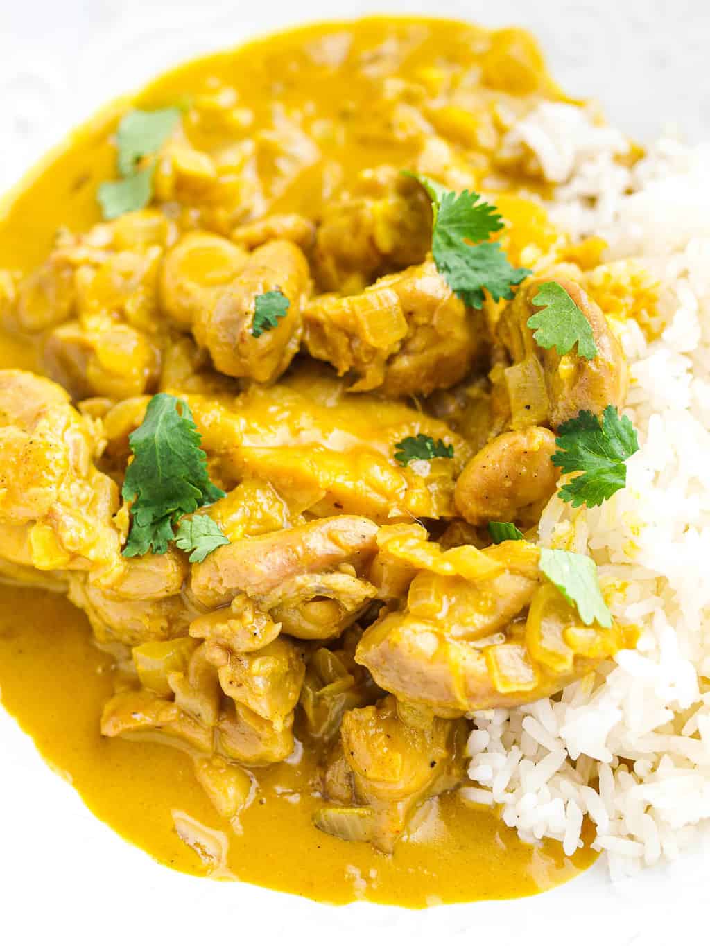 An up-close shot of a bowl of peanut butter chicken curry