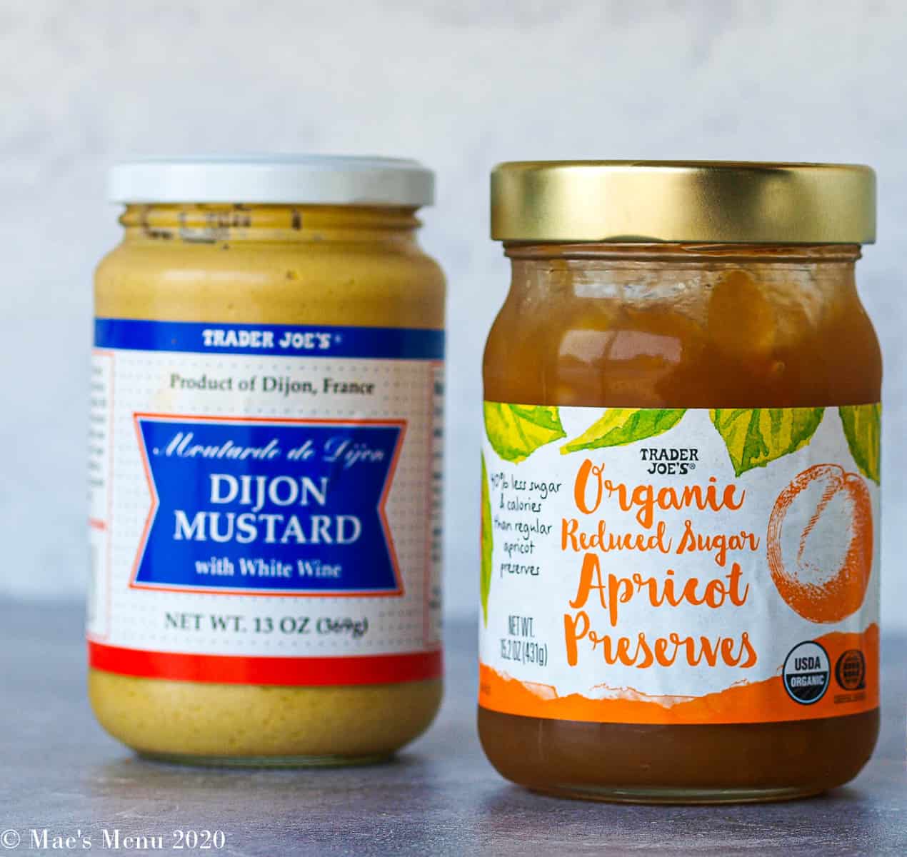 a jar of dijon mustard and a jar of reduced sugar apricot jam