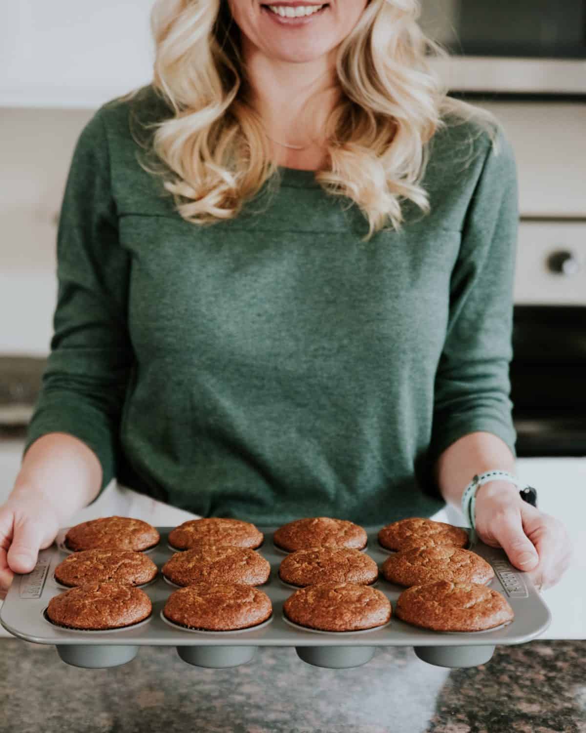 Chelsea Plummer holding a tray of muffins