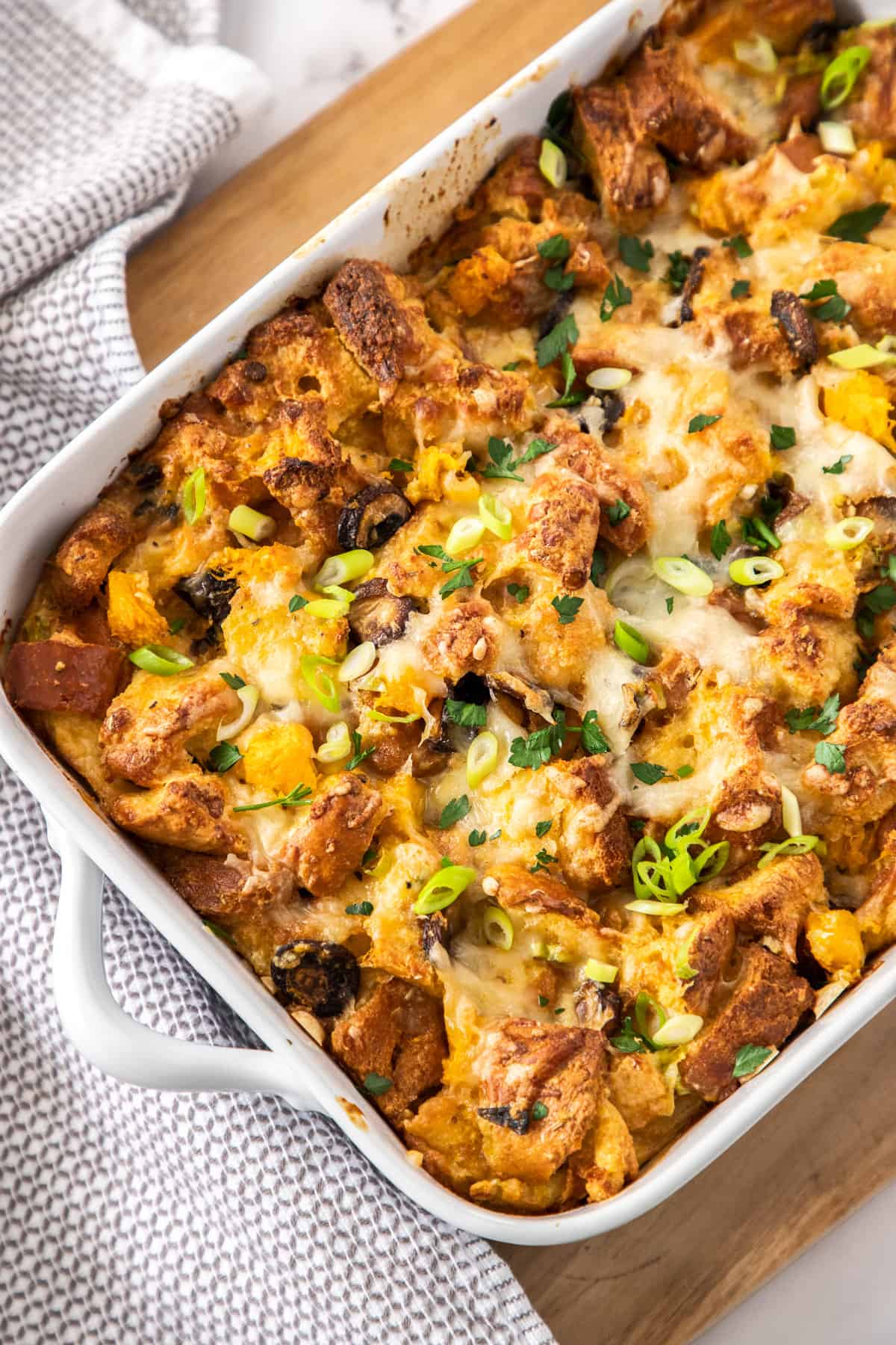 An overhead shot of savory bread pudding in a baking dish