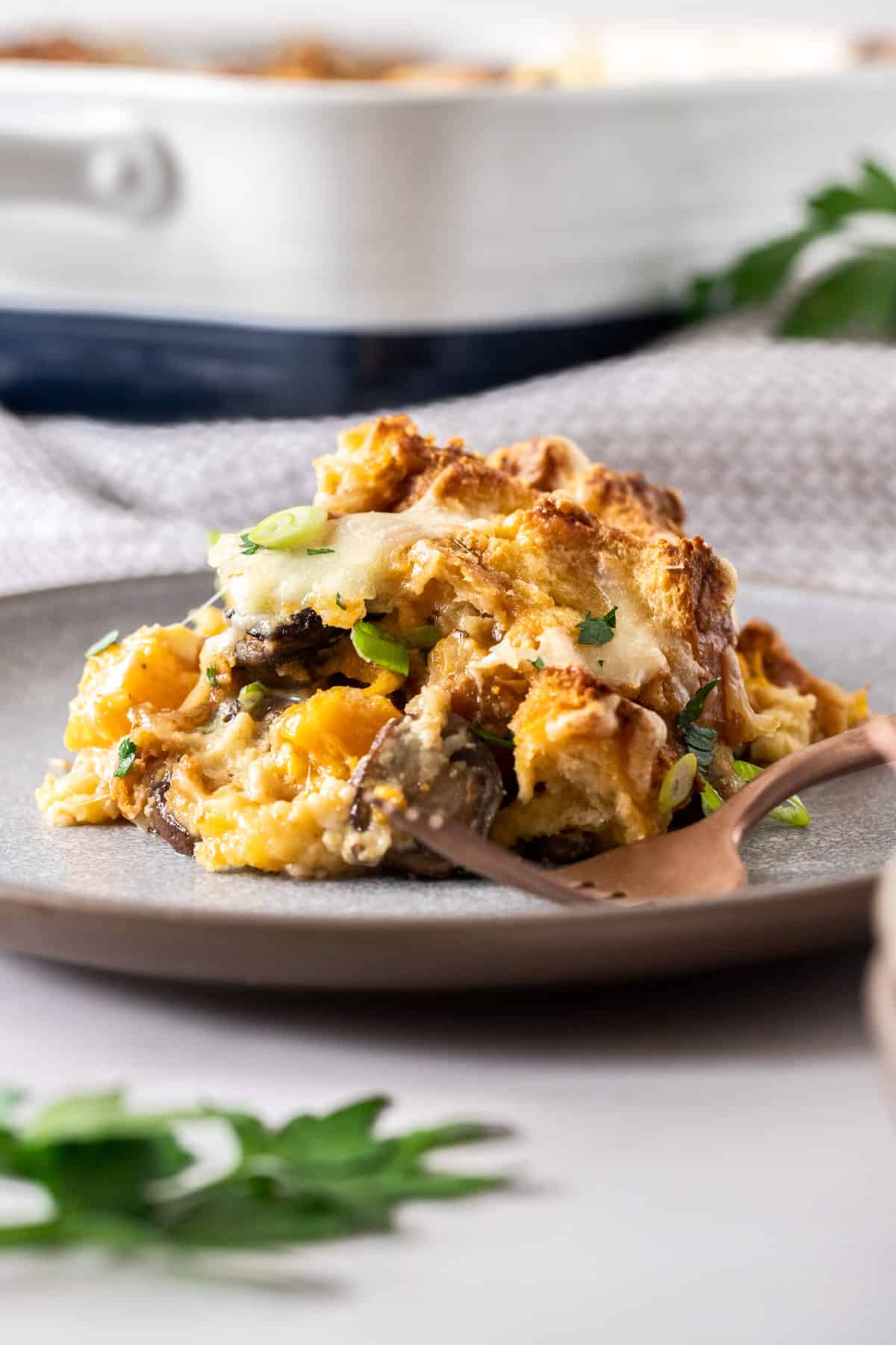 A single serving of savory bread pudding on a plate.