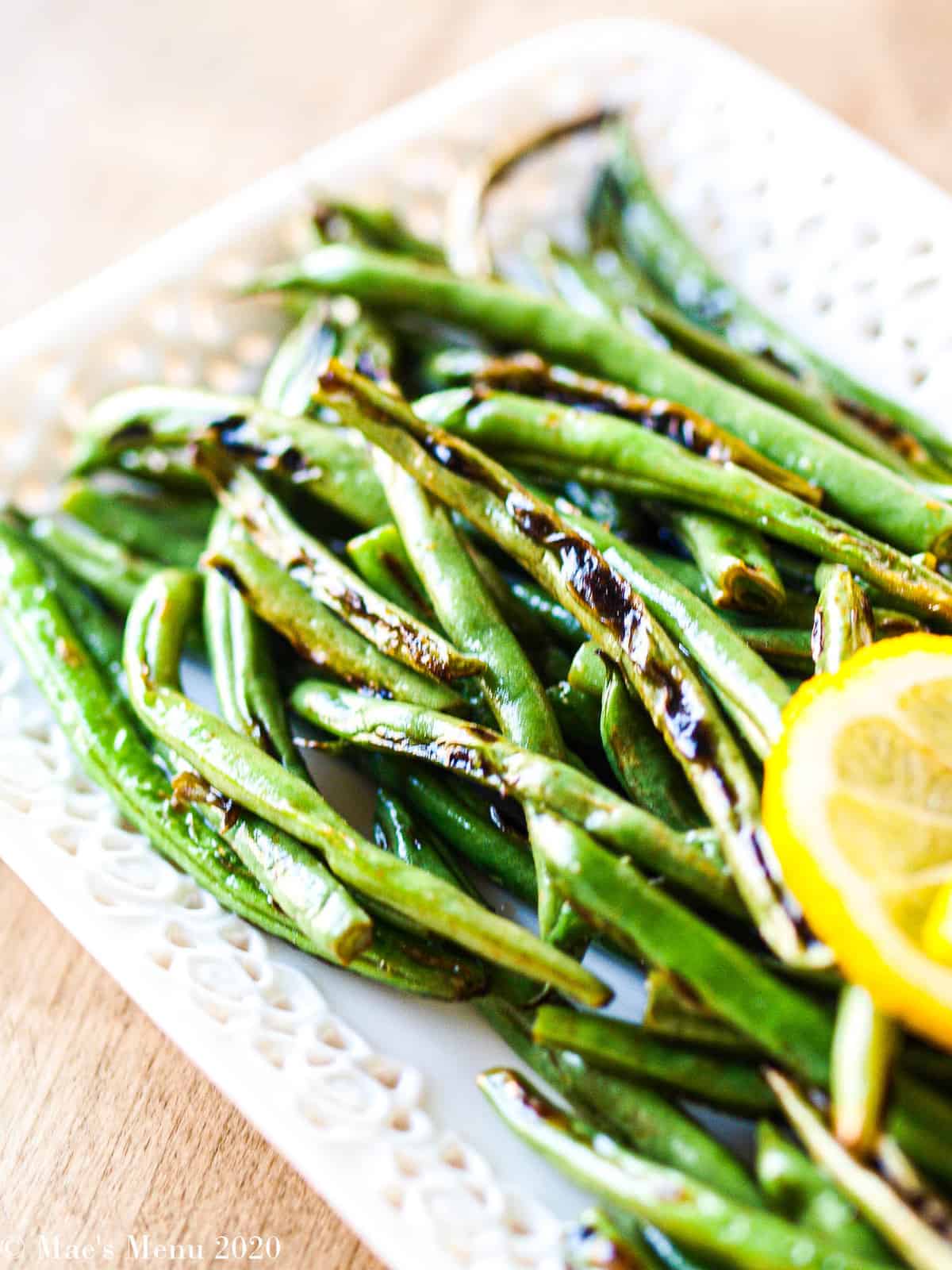 A side angled shot of a platter of green beans