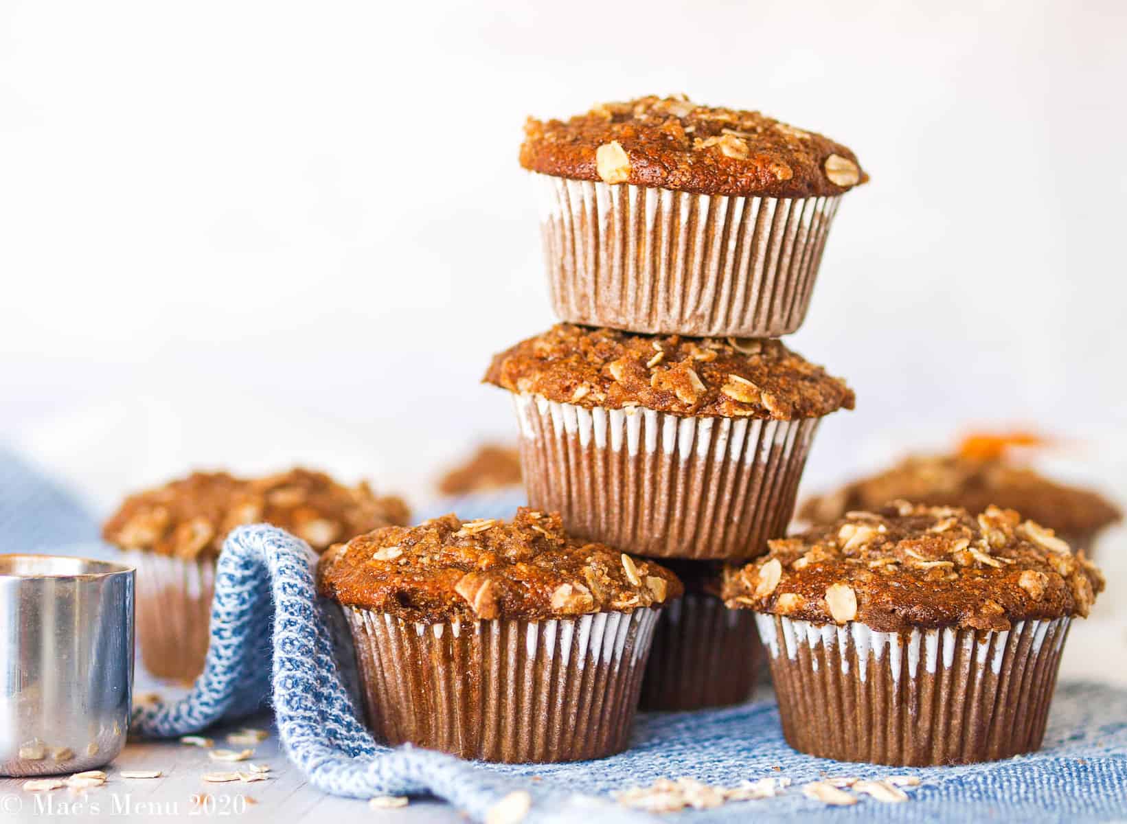 A stack of gluten-free pumpkin muffins on a blue and white towel