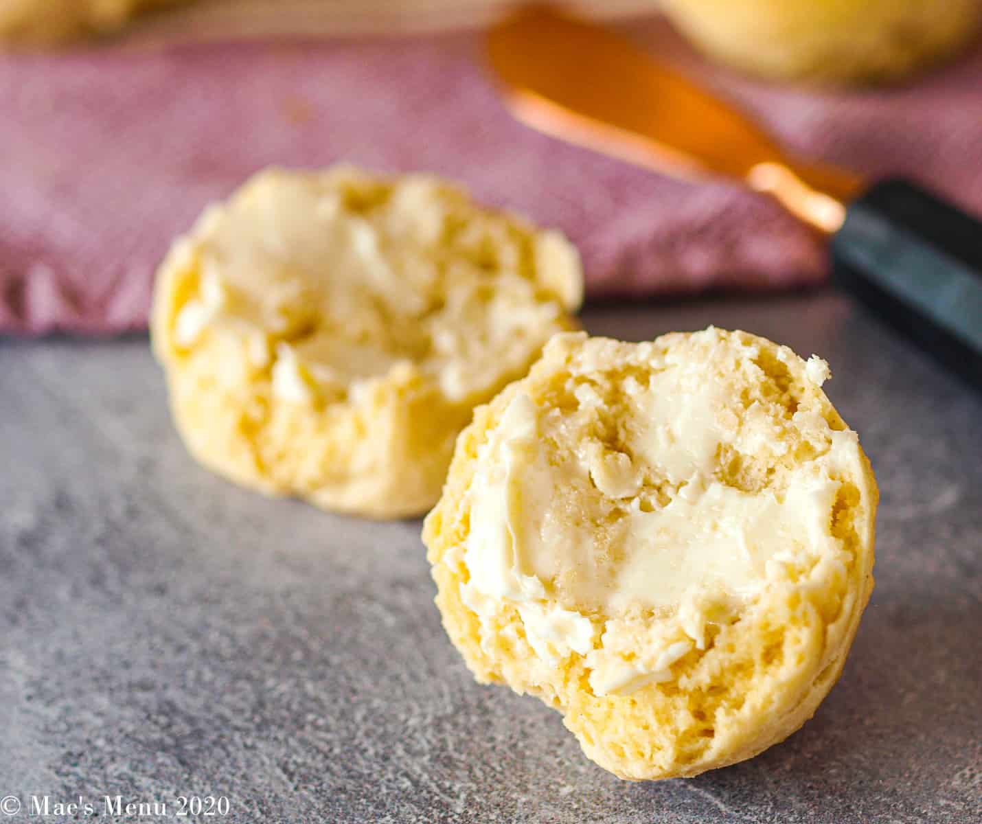 A no yeast dinner roll that's split with butter spread on it 