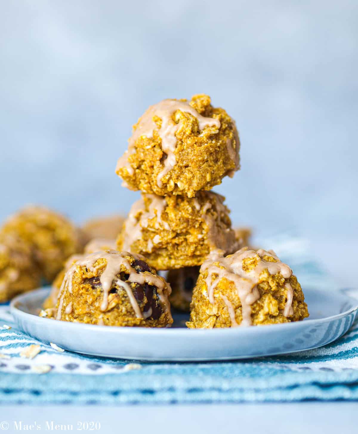 Oatmeal pumpkin cookies stacked on a blue plate