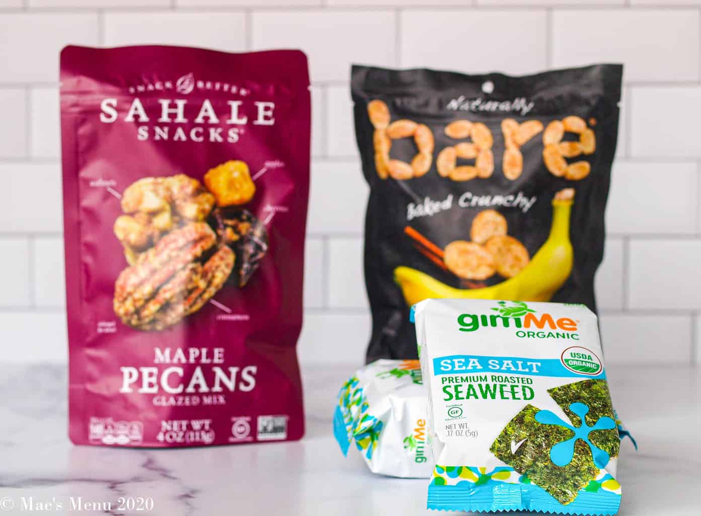 Snacks from thrive market on the counter: a bag of Sahale snacks, bare baked crunchy apples and 2 small containers of seaweed