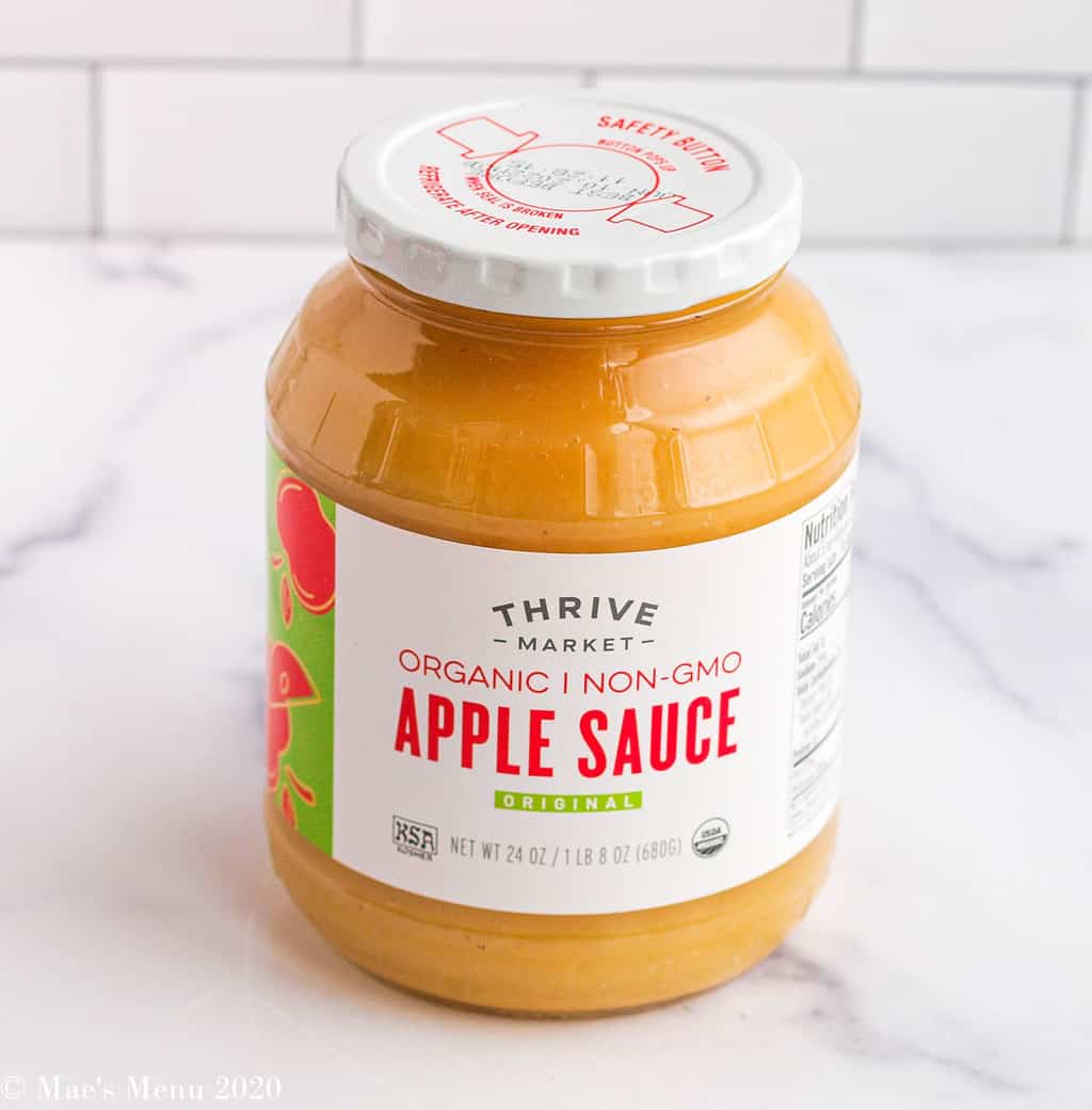 A bottle of Thrive Market organic no-GMO apple sauce on the counter 