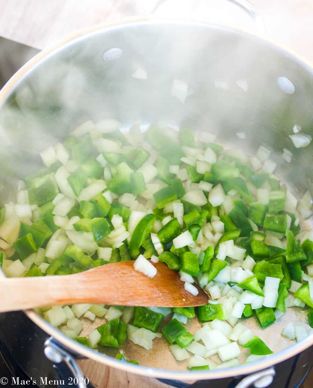 Onions and green peppers sauteing on the stovetop