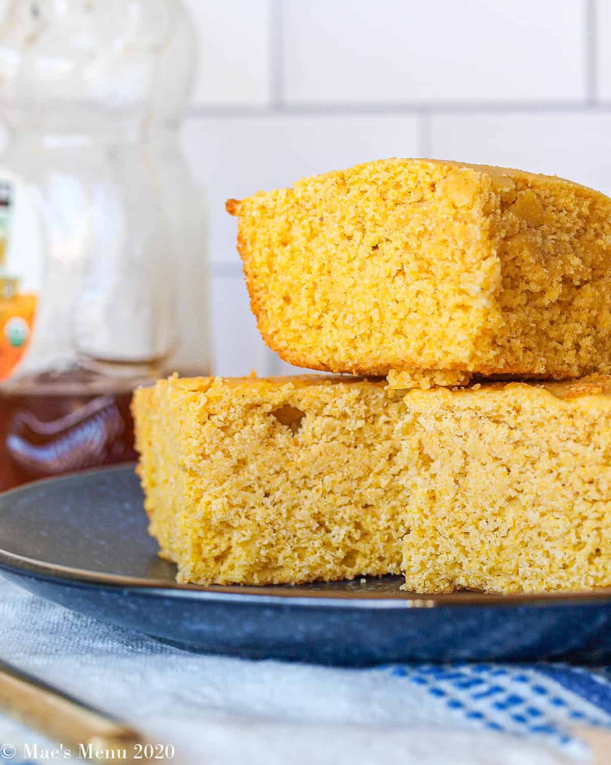 A side shot of 3 pieces of gluten-free cornbread stacked on top of eachother