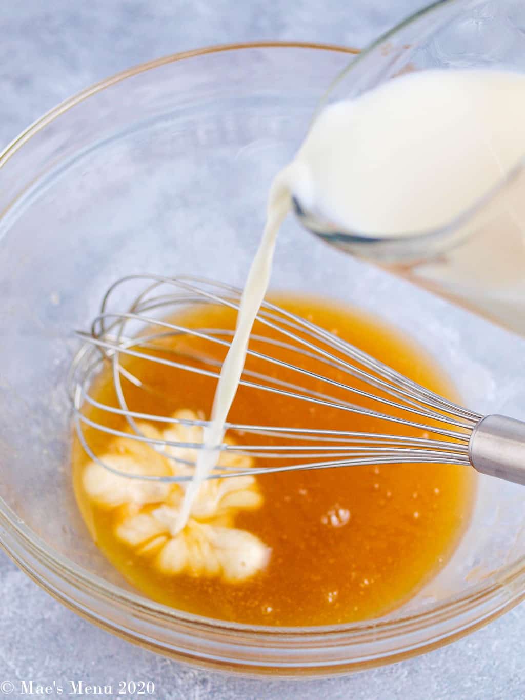 Pouring milk into the melted butter and honey