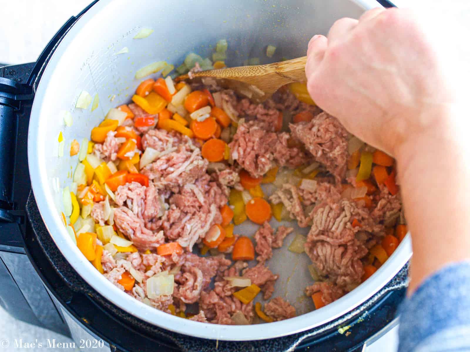 Adding the turkey to the instant pot and stirring