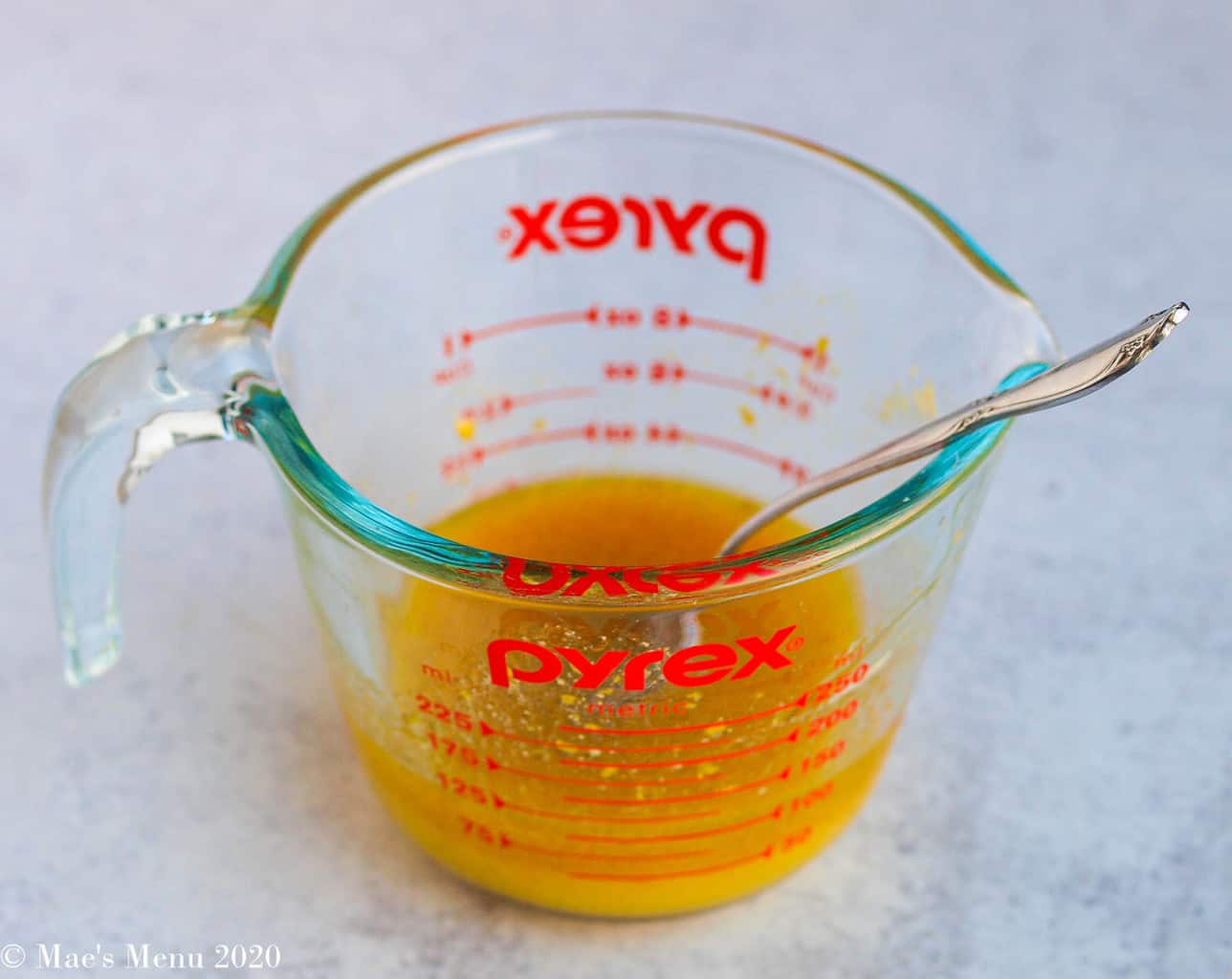 Whisking up the vinaigrette in a glass measuring cup