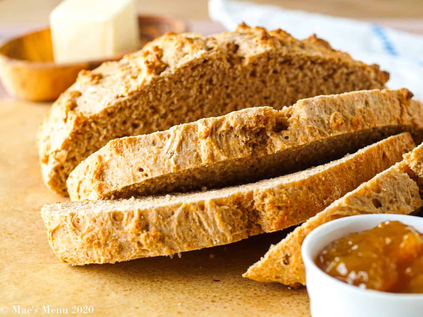 A side shot of a sliced loaf of whole wheat beer bread 
