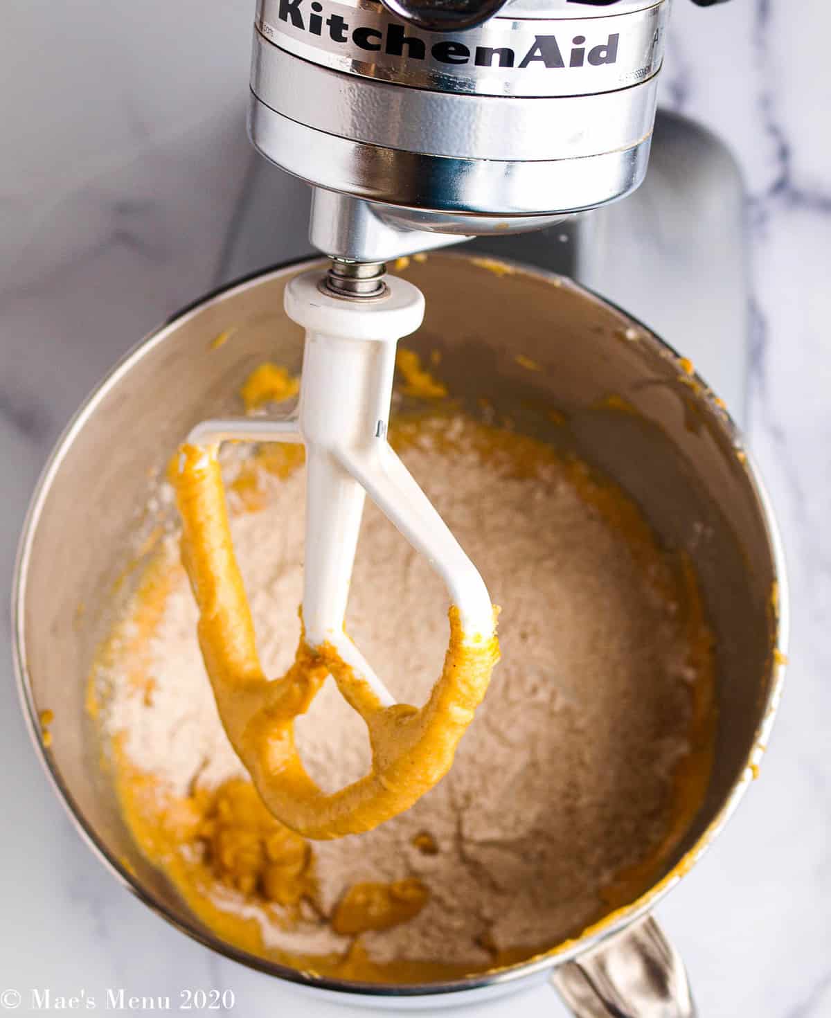 Adding the flour to the peanut butter mixture in a stand mixer