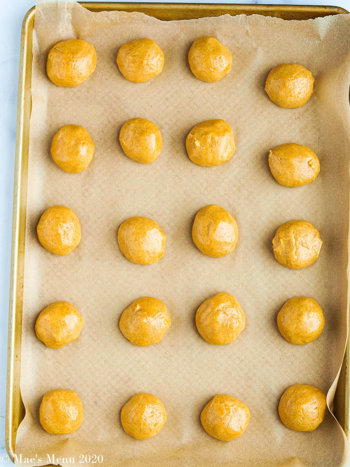 balls of whole wheat peanut butter cookies on a baking sheet