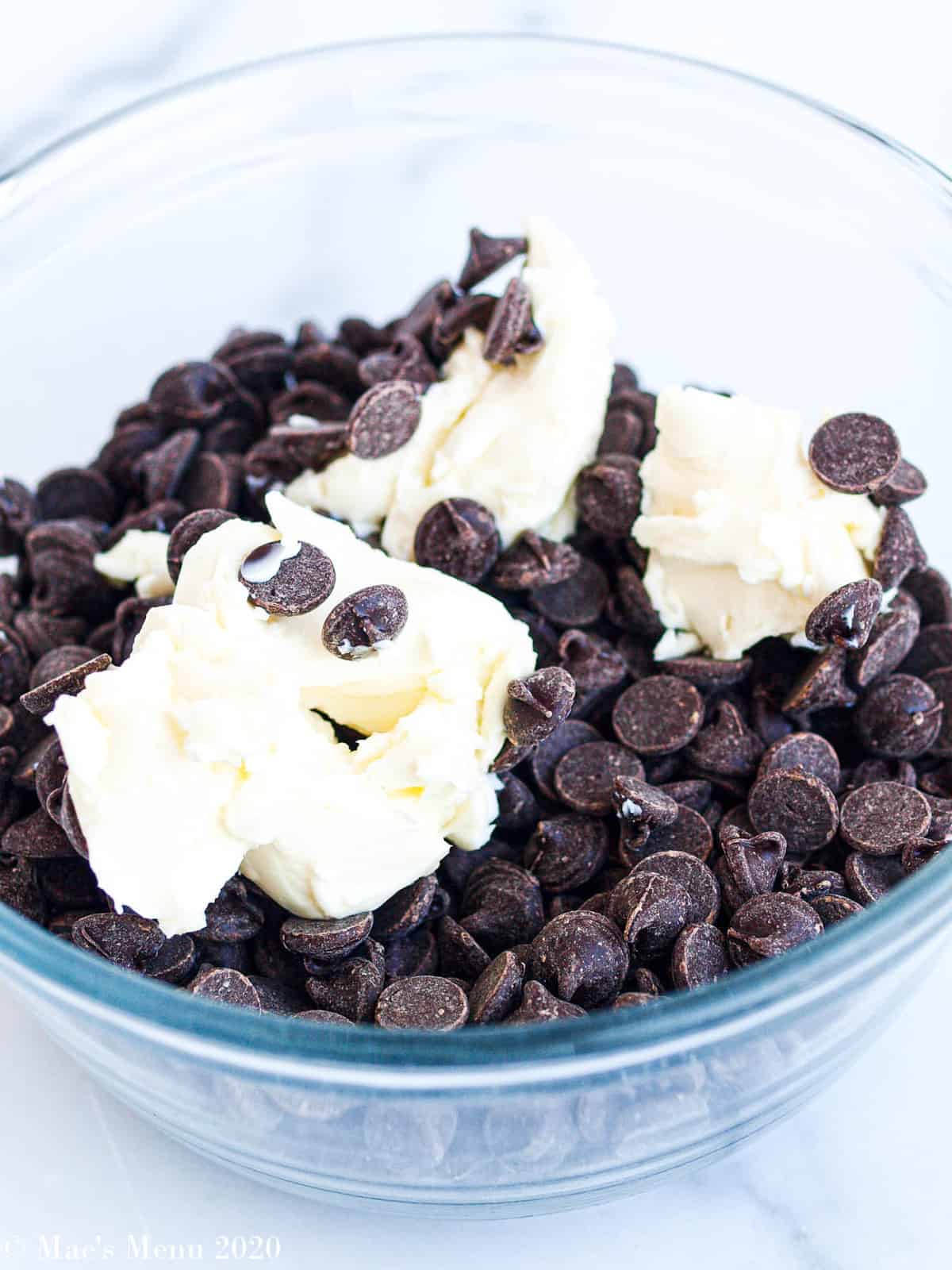 A mixing bowl with chocolate chips and butter