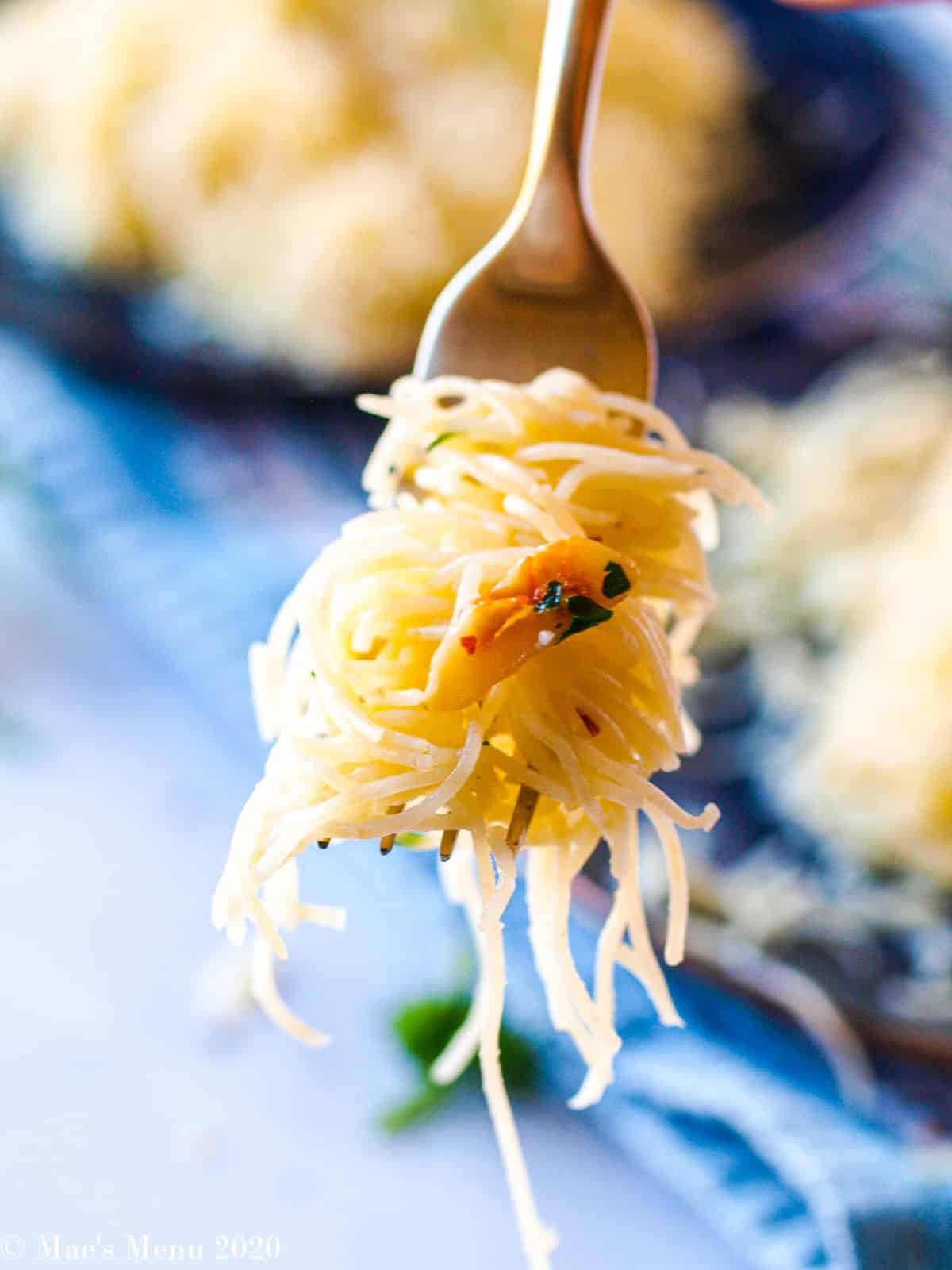 A fork full of garlic angel hair pasta 
