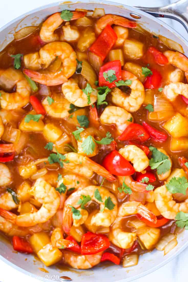An overhead shot of a large non-stick pan pull of sweet and sour shrimp