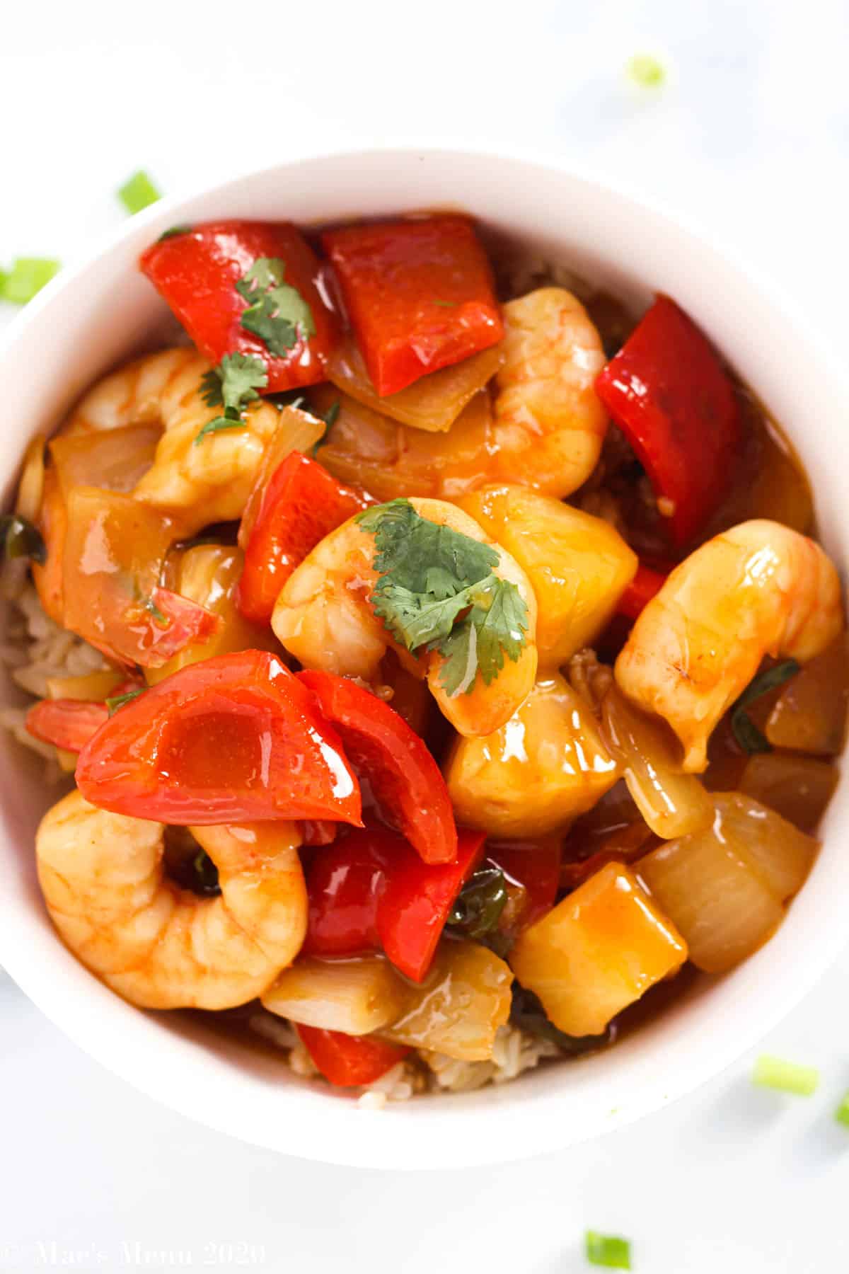 An up close overhead shot of a bowl of sweet and sour shrimp