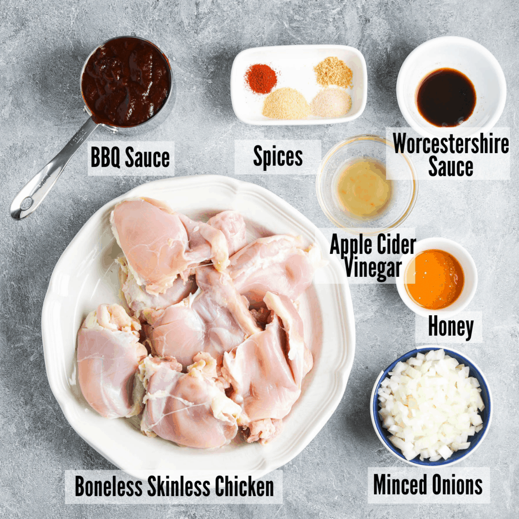 All the ingredients for instant pot bbq chicken: bbq sauce, spices, worcestershire, apple cider vinegar, honey, minced onions, and boneless skinless chicken